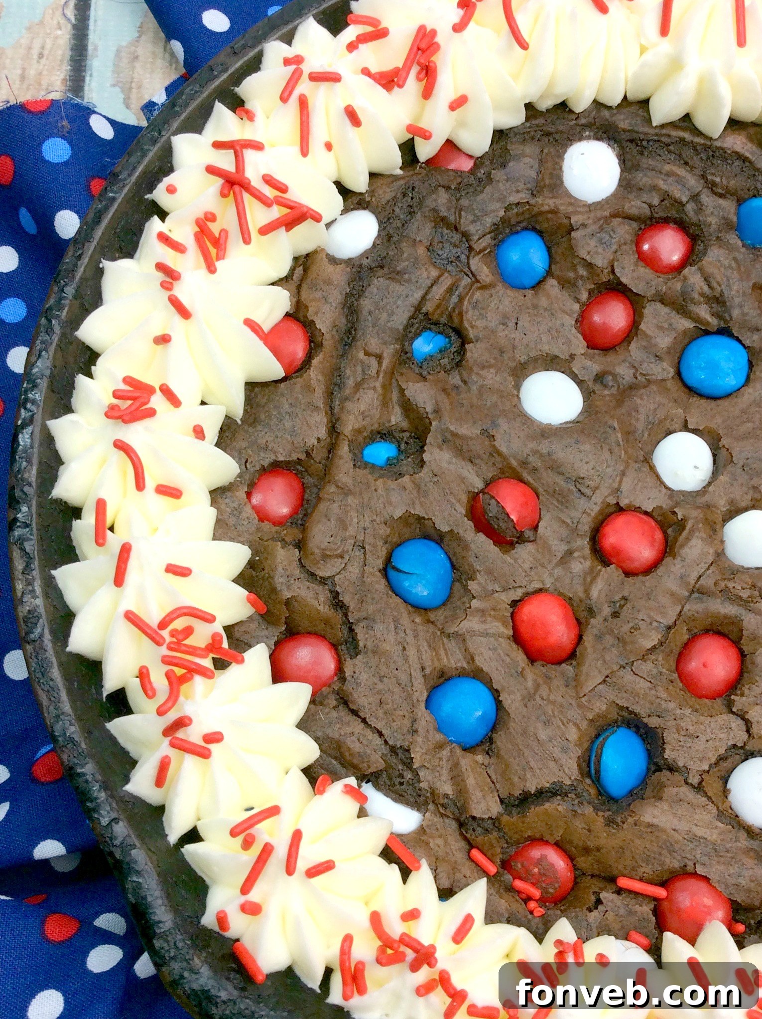 Gooey Skillet Fudge Brownie Perfection 3 Close-up of the brownie batter in a cast iron skillet, sprinkled with various colorful candies and chocolate chips.