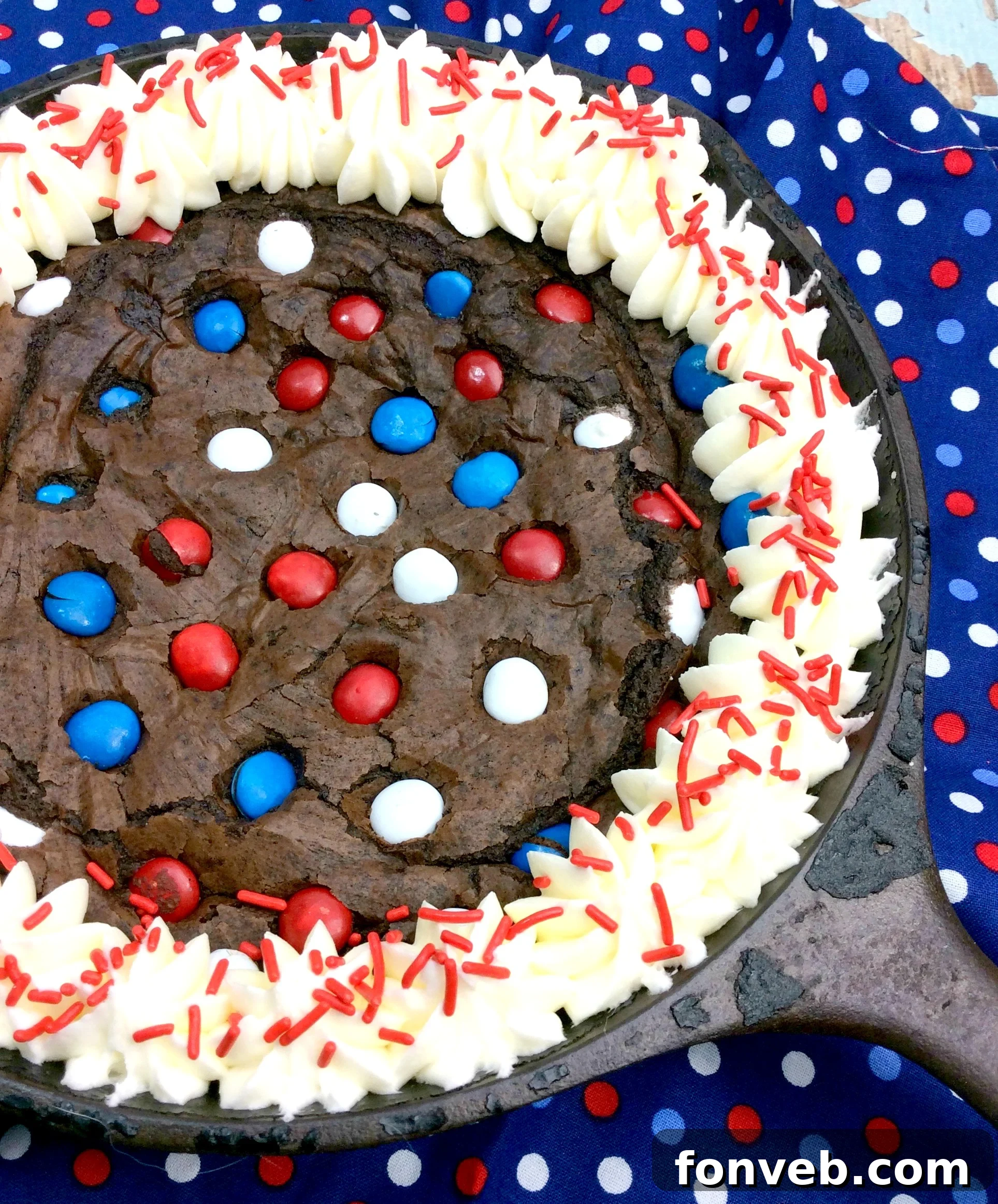 Gooey Skillet Fudge Brownie Perfection 5 A partially eaten Cast Iron Fudge Brownie Skillet, showing the gooey interior and delicious frosting, inviting another spoonful.