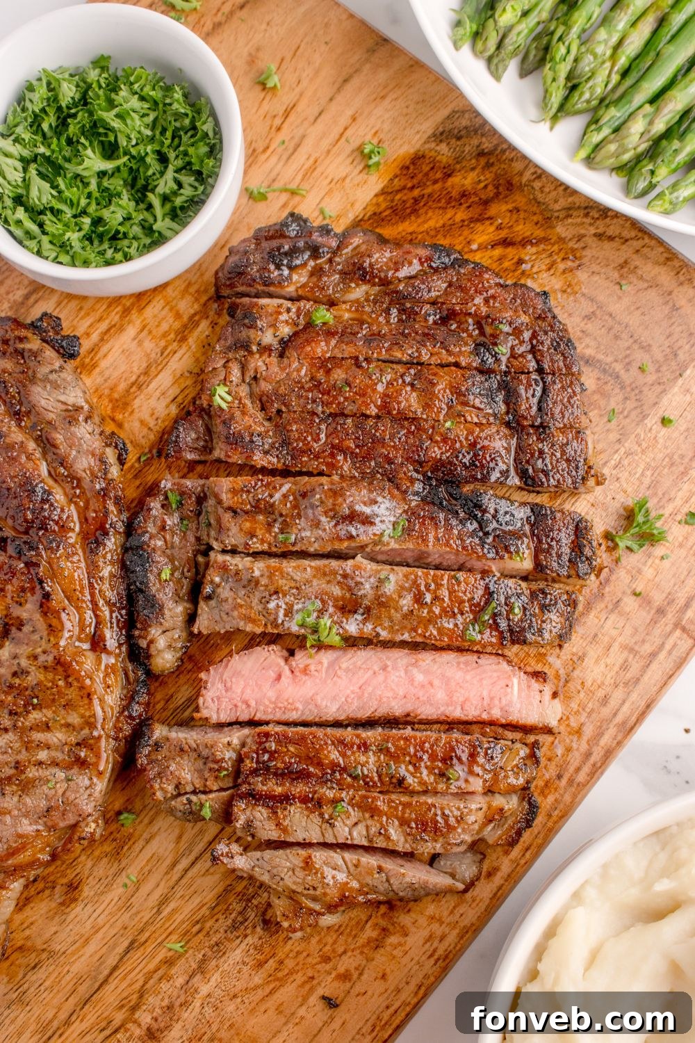 Grilled Ribeye Steaks sliced into strips showing a medium rare steak 