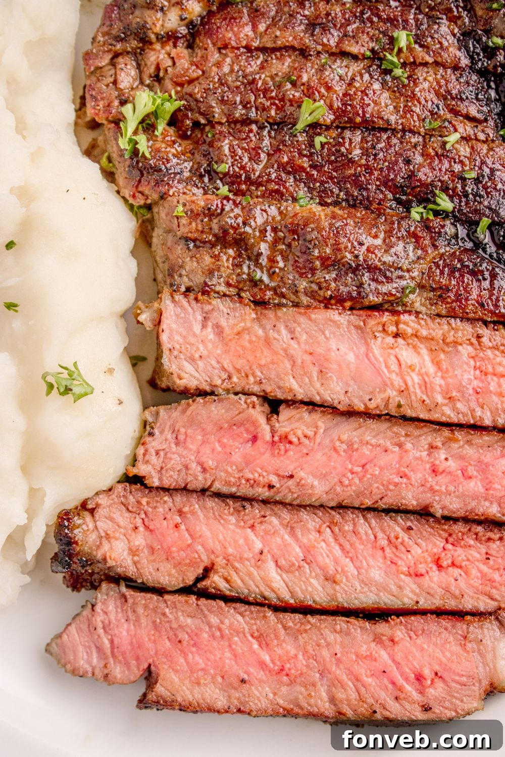 overhead look on plate with Grilled Ribeye Steak sliced on plate 