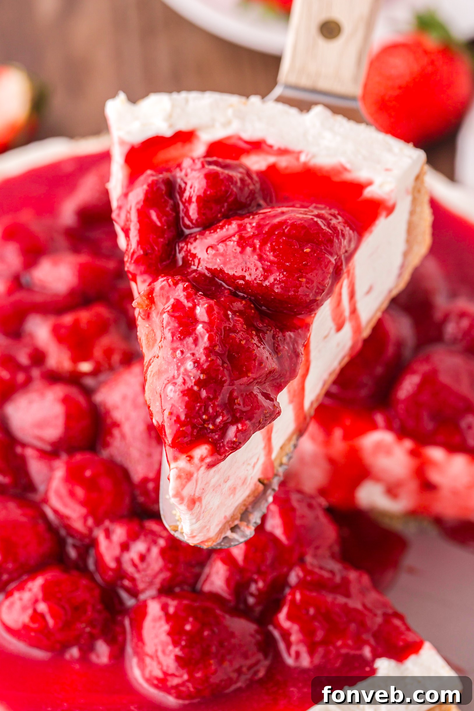 slice of No Bake Strawberry Cheesecake being lifted up 