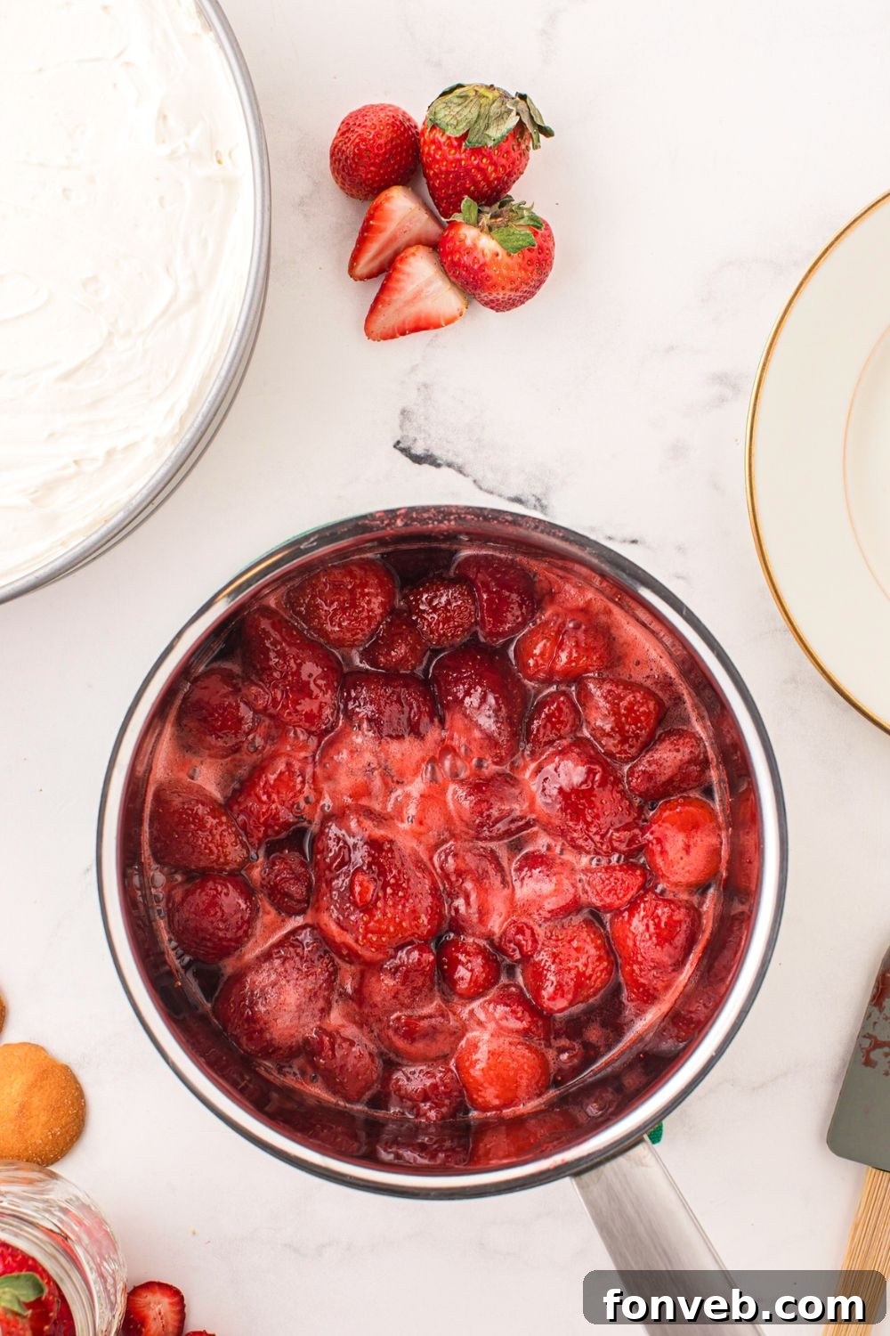 strawberries cooked into a glaze for topping the no bake cheesecake 