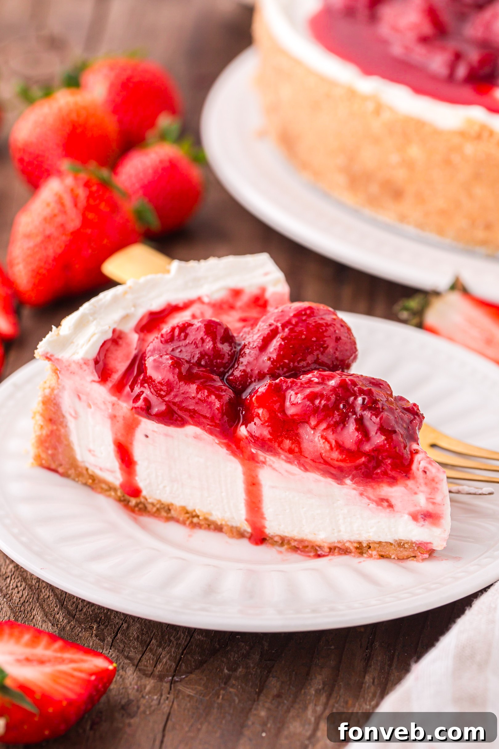big slice of the No Bake Strawberry Cheesecake on a white plate 