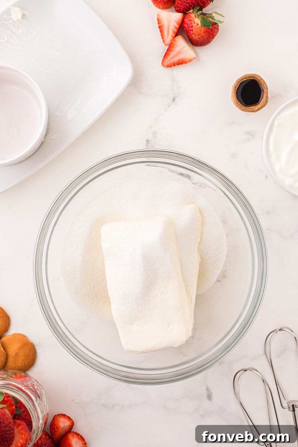 cream cheese and sugar in a glass bowl on table 