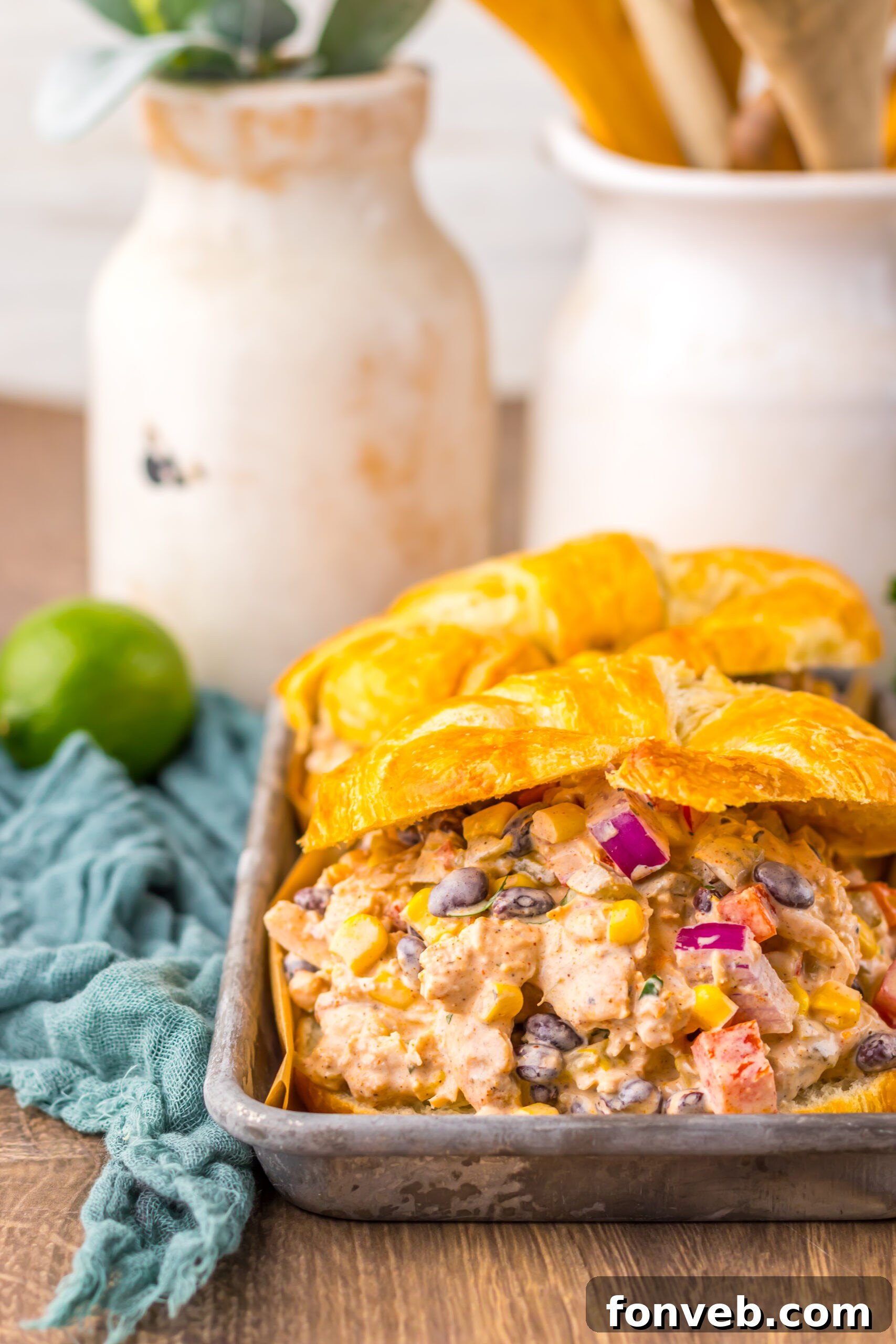 Creamy Taco Chicken Salad in a croissant in a silver serving platter 