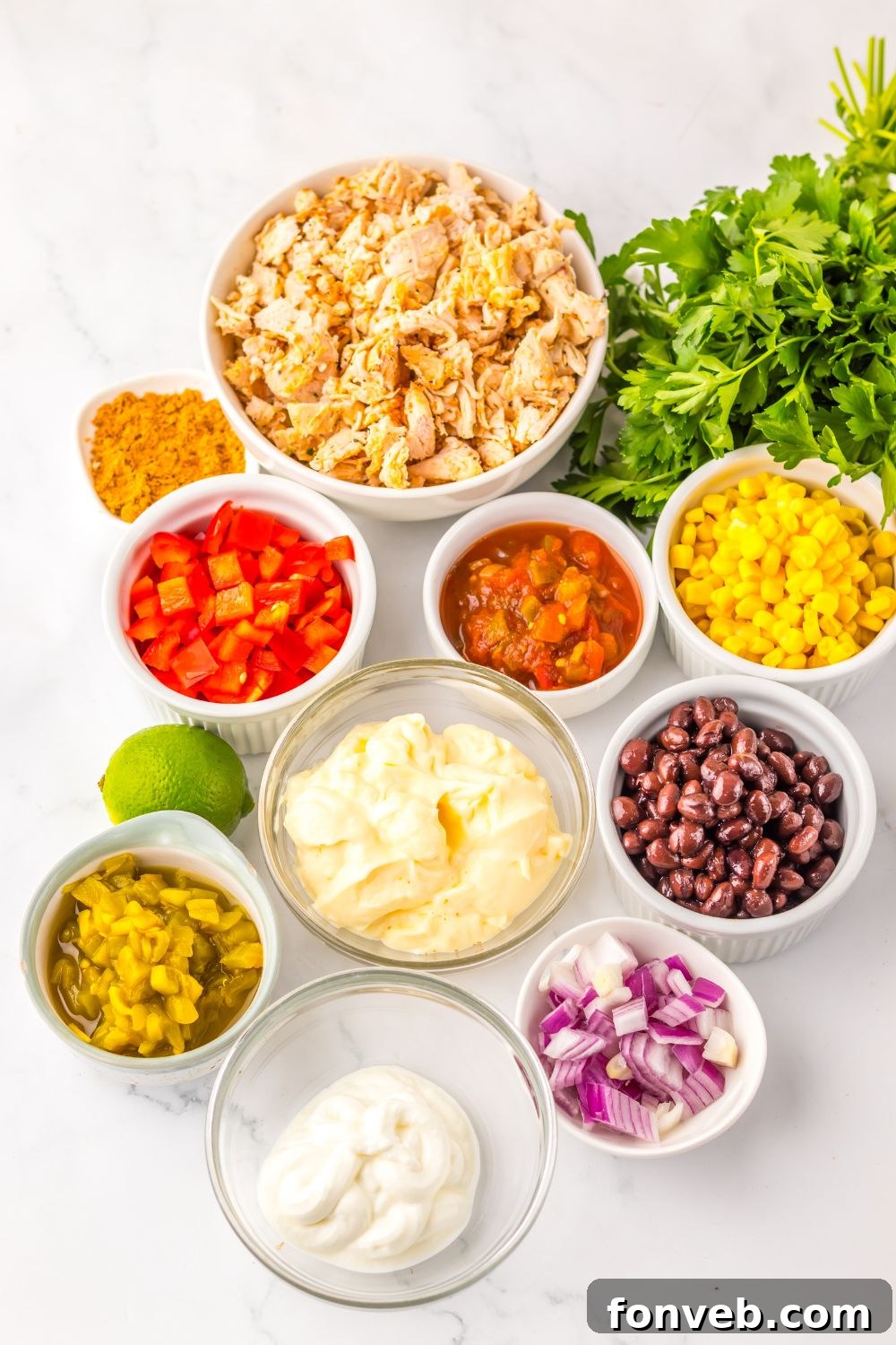 ingredients for Creamy Taco Chicken Salad  in single serve bowls sitting on table 