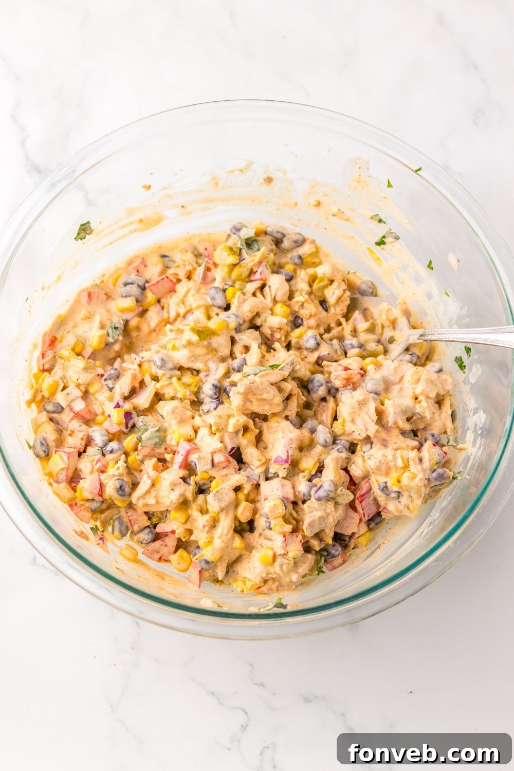 Creamy Taco Chicken Salad  in a glass bowl mixed up 