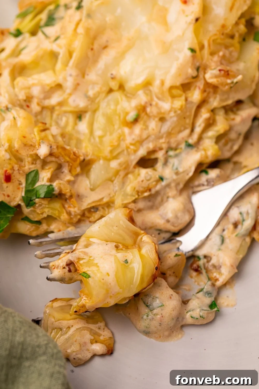 Keto Creamy Garlic Parmesan Cabbage Skillet 13 Creamy Garlic Parmesan Cabbage on a plate with a forkful ready to eat