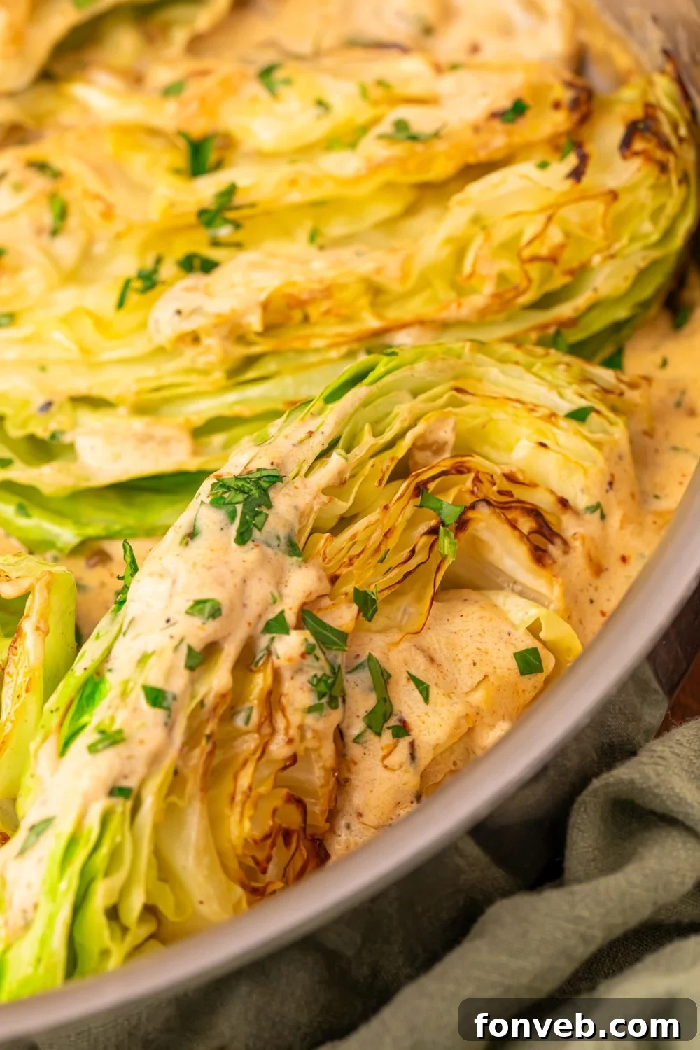 Keto Creamy Garlic Parmesan Cabbage Skillet 15 Close-up of Creamy Garlic Parmesan Cabbage in a skillet, garnished with parsley