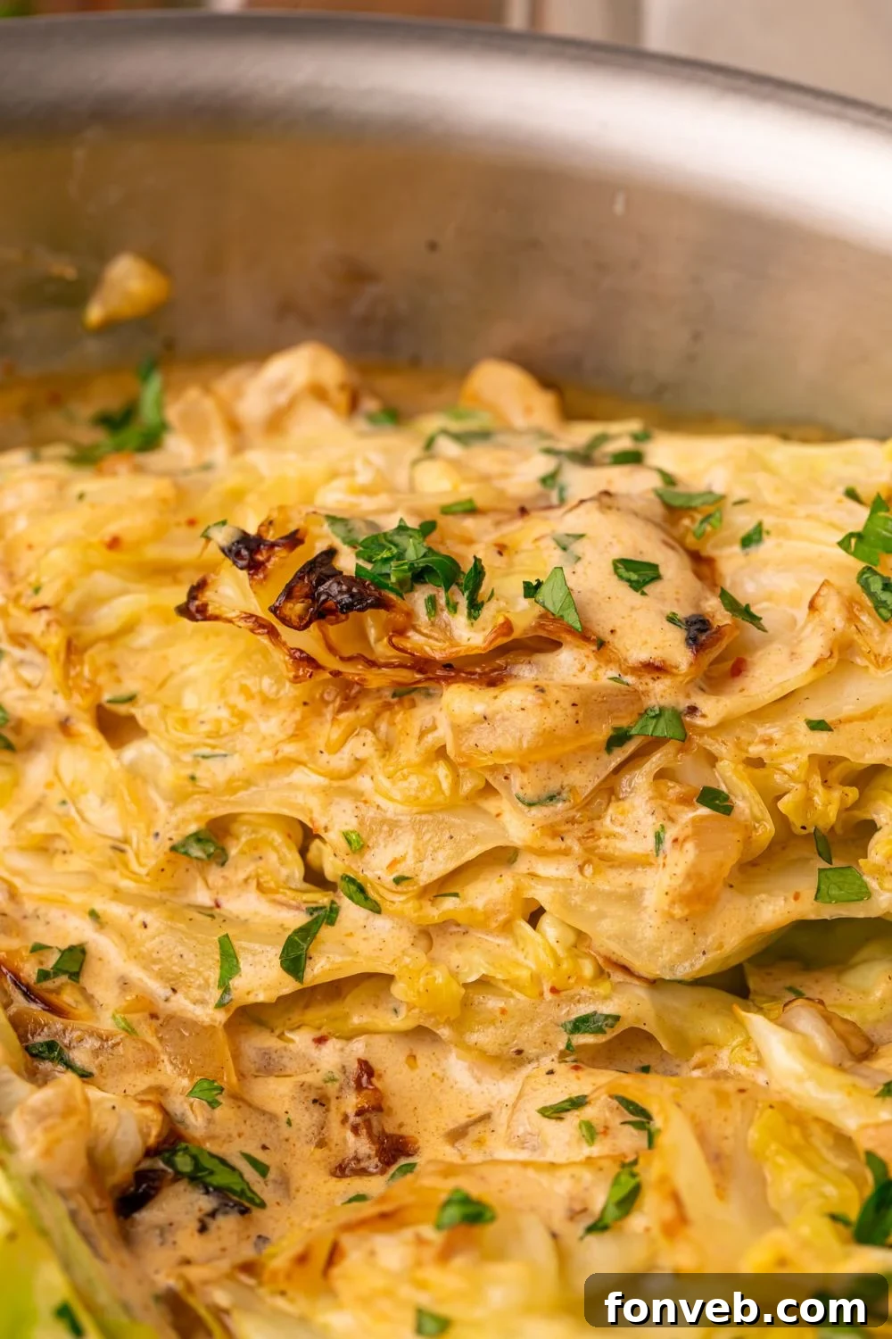 Keto Creamy Garlic Parmesan Cabbage Skillet 17 Creamy Garlic Parmesan Cabbage in a pan with chopped parsley on top