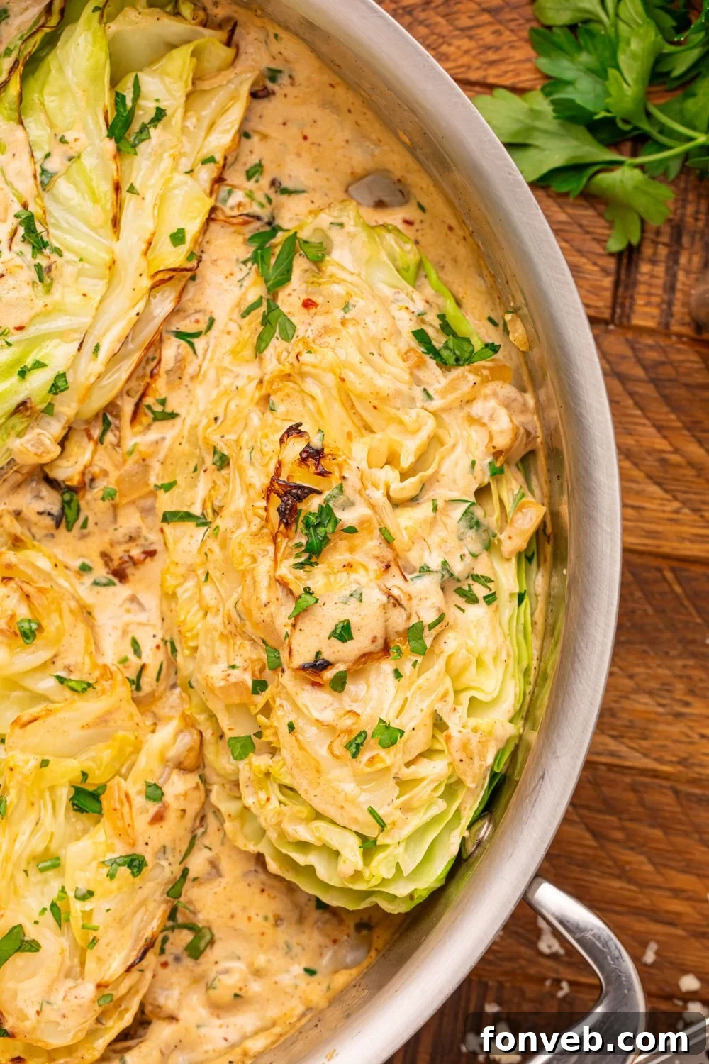Keto Creamy Garlic Parmesan Cabbage Skillet 18 Creamy Garlic Parmesan Cabbage in a skillet with parsley and salt and pepper shakers