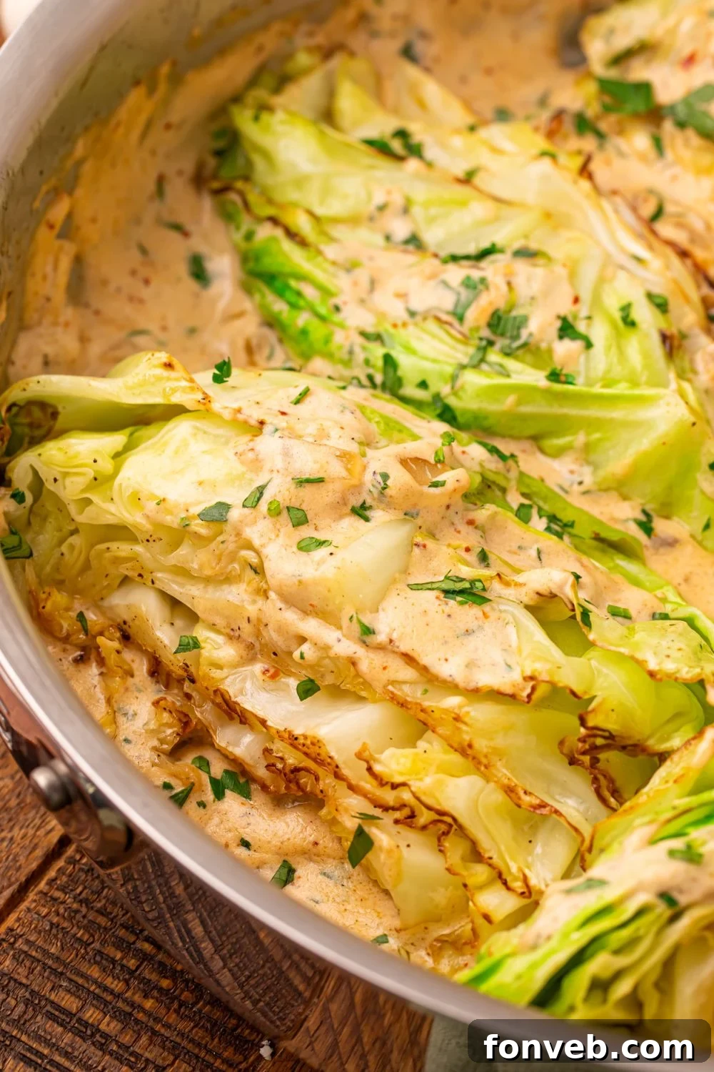 Keto Creamy Garlic Parmesan Cabbage Skillet 23 Close-up of Creamy Garlic Parmesan Cabbage in a skillet showing the sautéed texture