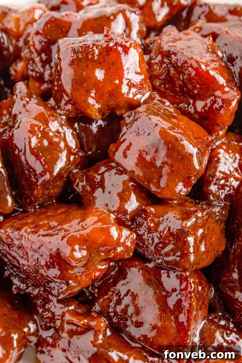 A close-up shot of perfectly cooked Chuck Roast Burnt Ends, piled high, showcasing their smoky char and sticky glaze, ready to be enjoyed.