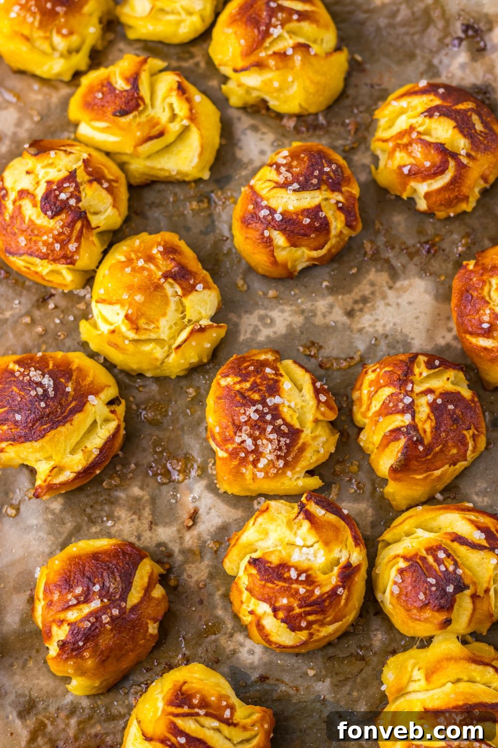 pretzel bites on cooking tray on table sprinkled with salts 
