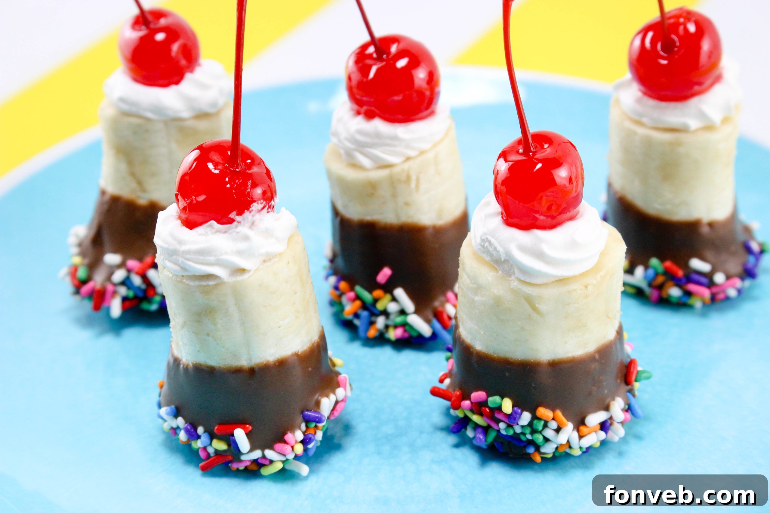 Banana Split Delights 3 Child's hands dipping a banana segment into melted chocolate, showing the fun of making these bites.
