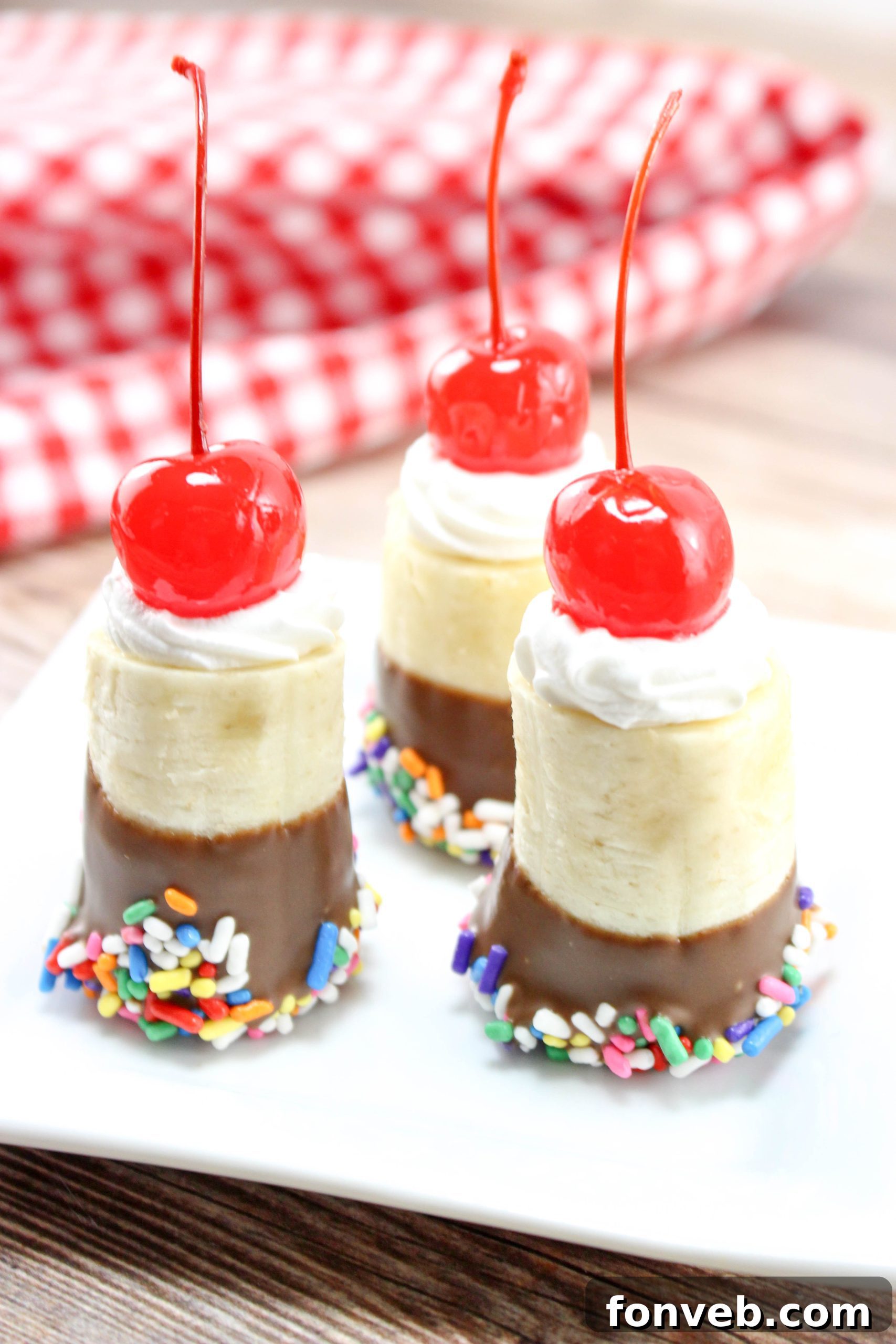 Banana Split Delights 6 Finished banana split bites served on a platter with a small bowl of vanilla ice cream in the background.