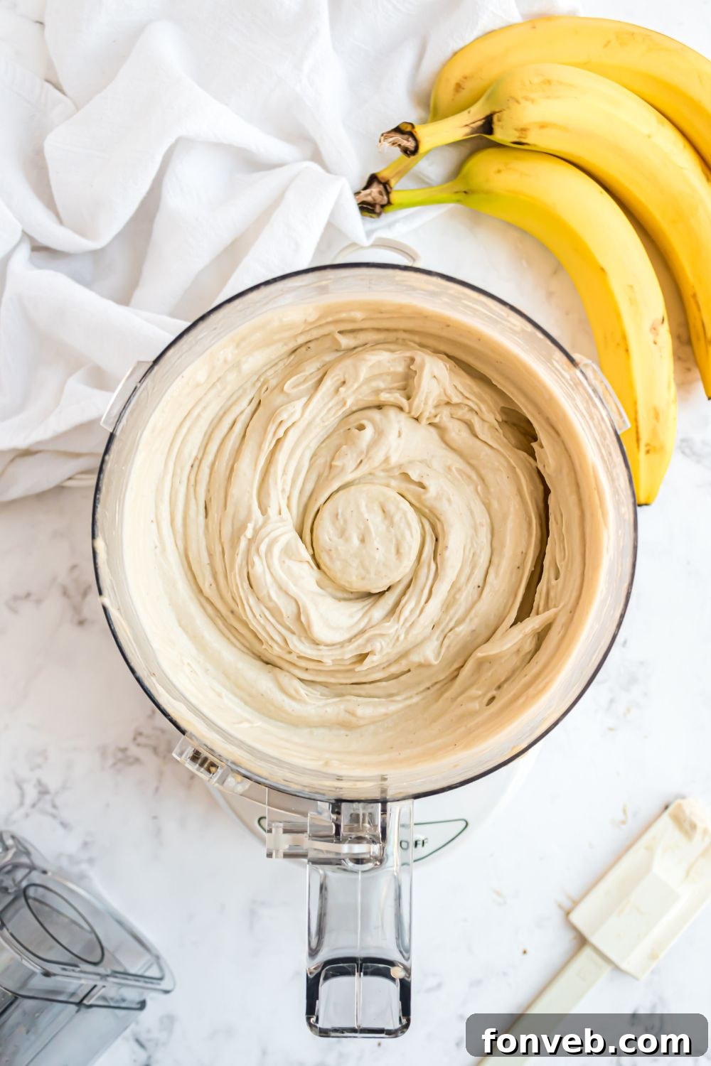 Banana Ice Cream: The One-Ingredient Wonder 11 Banana Ice Cream in a food processor all mixed up with bananas to side