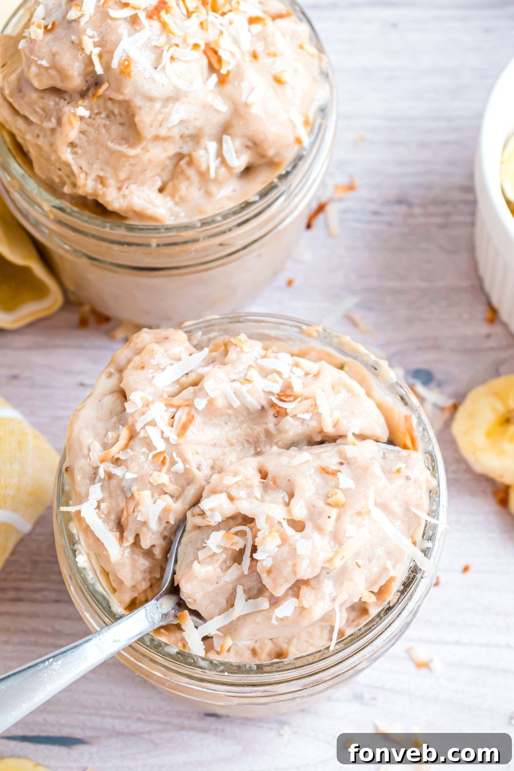 Banana Ice Cream: The One-Ingredient Wonder 14 Banana Ice Cream in a glass bowl with spoon inside bowl and toppings on top of ice cream