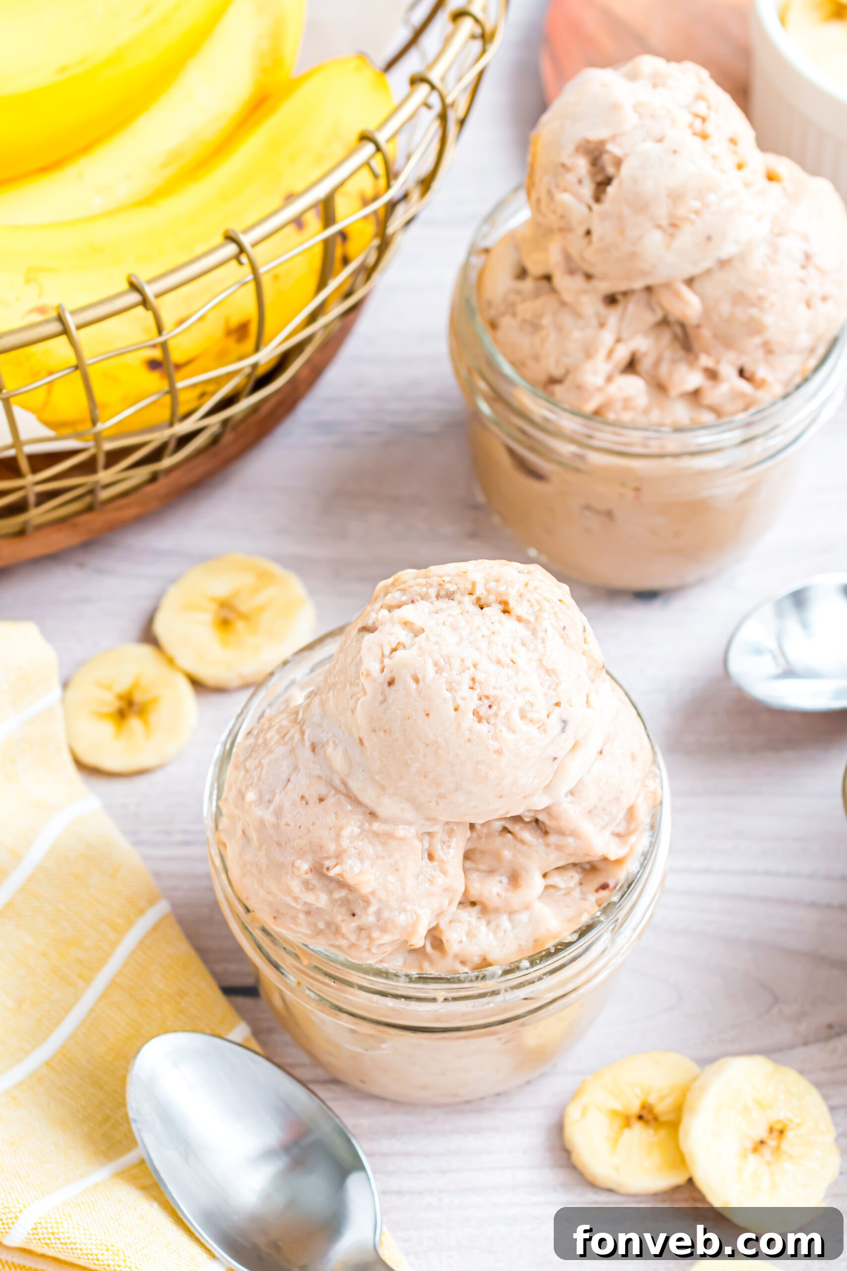 Banana Ice Cream: The One-Ingredient Wonder 25 overhead shot of the Banana Ice Cream in a glass bowl on table with slices of bananas around table