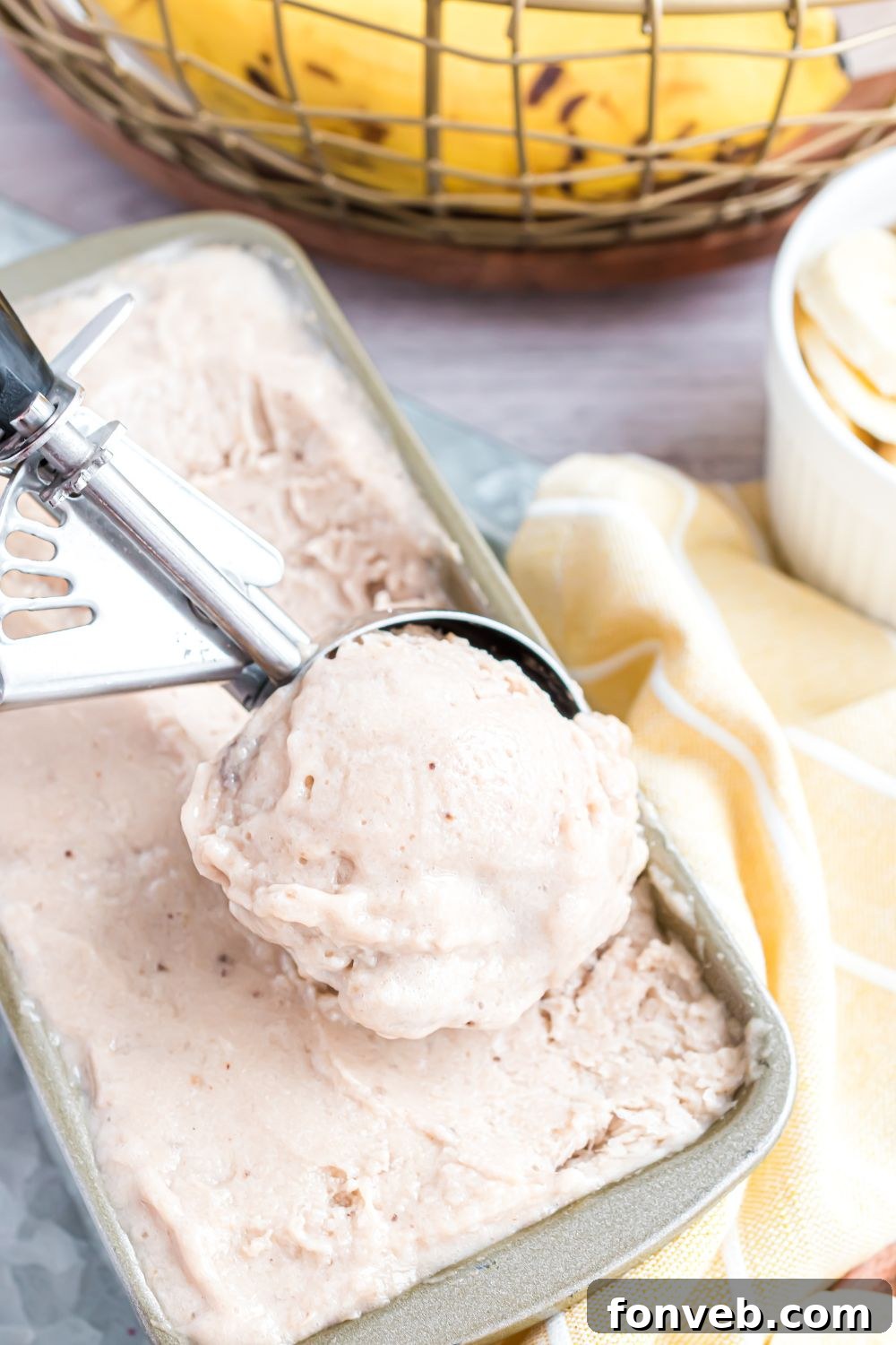 Banana Ice Cream: The One-Ingredient Wonder 5 Banana Ice Cream in a loaf pan with an ice cream scoop full of ice cream
