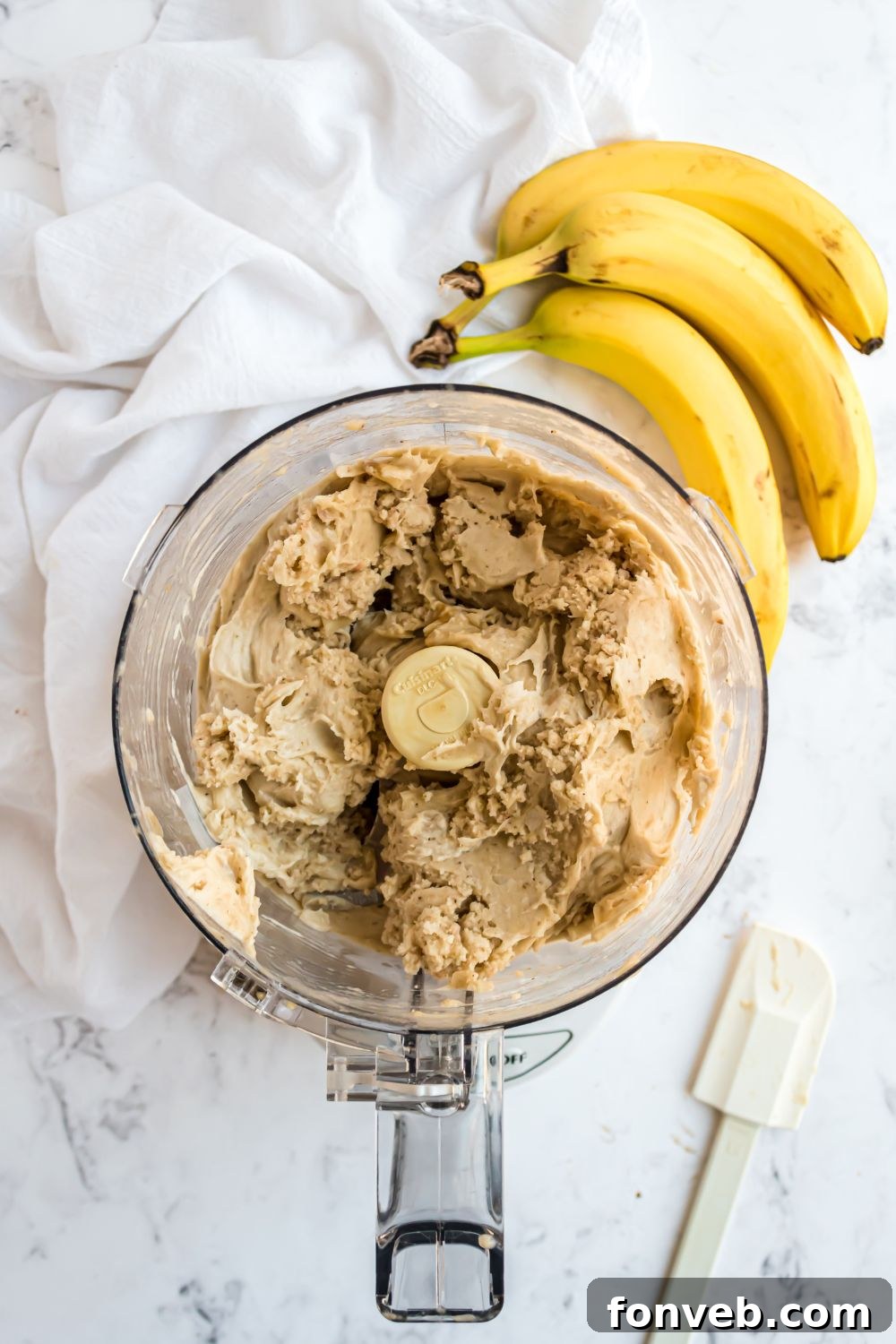 Banana Ice Cream: The One-Ingredient Wonder 10 Banana Ice Cream being made in a food processor with bananas to side