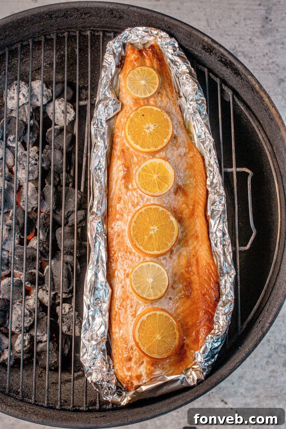 Effortless Honey Mustard Salmon Foil Grill 11 charcoal grill with Grilled Honey Mustard Salmon in Foil on top of rack
