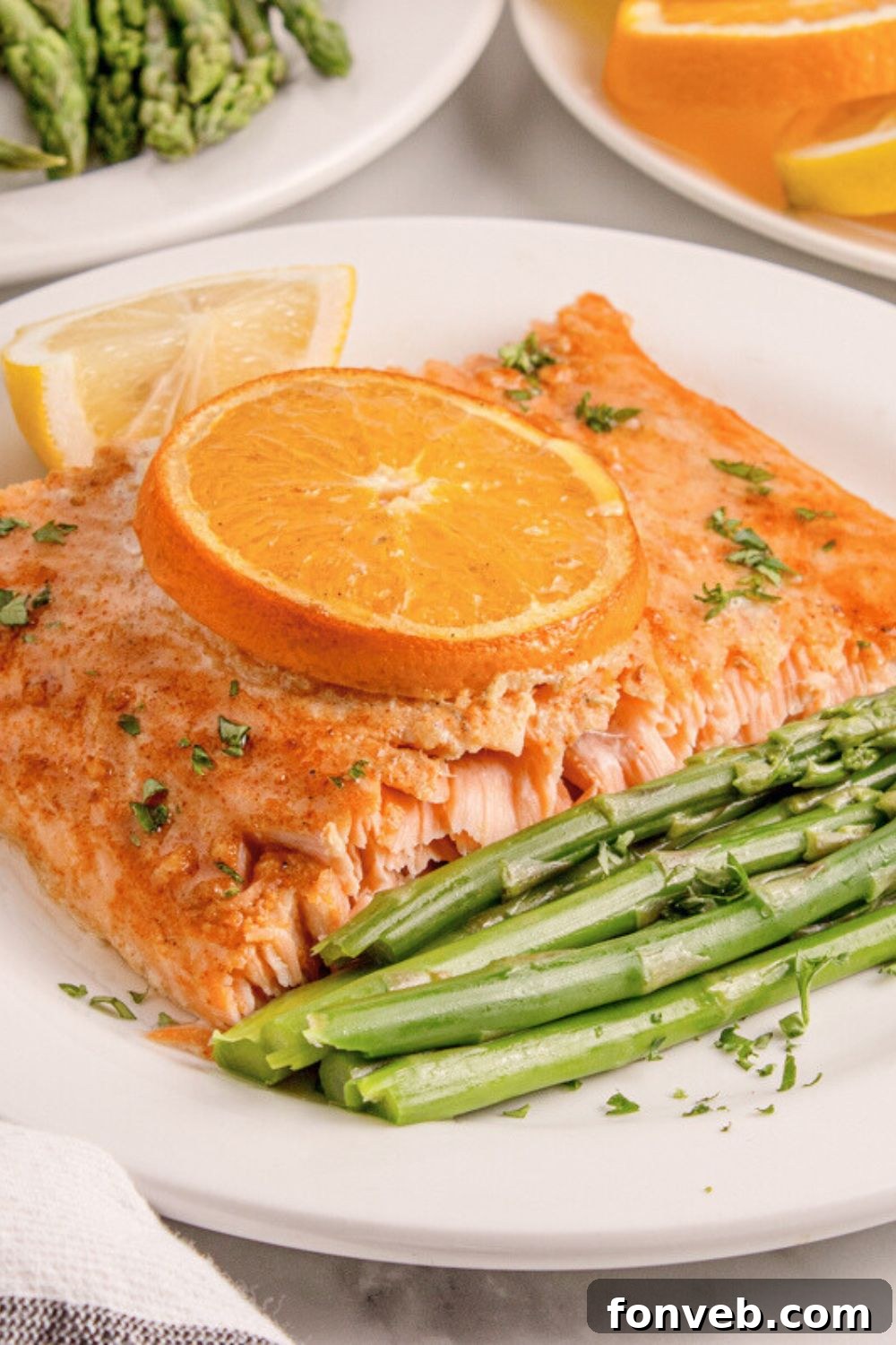 Effortless Honey Mustard Salmon Foil Grill 19 Grilled Honey Mustard Salmon on plate with asparagus and lemon wedge to side of plate