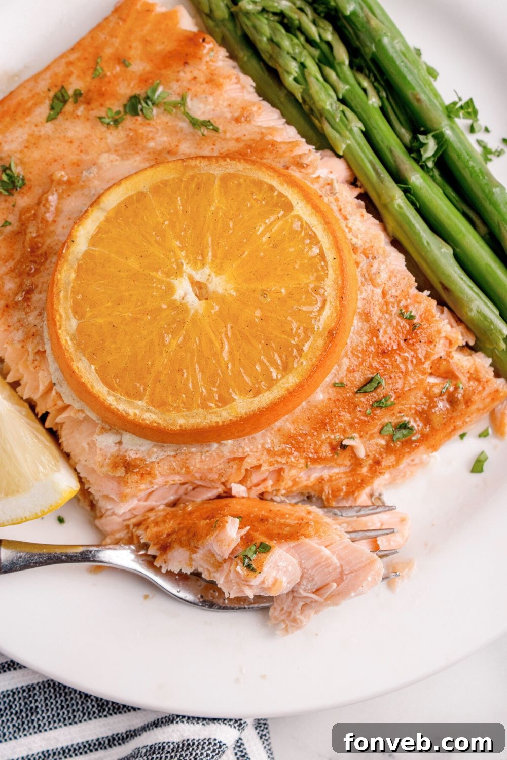 Effortless Honey Mustard Salmon Foil Grill 3 plate with grilled honey mustard salmon with orange slice on top and veggies to the side