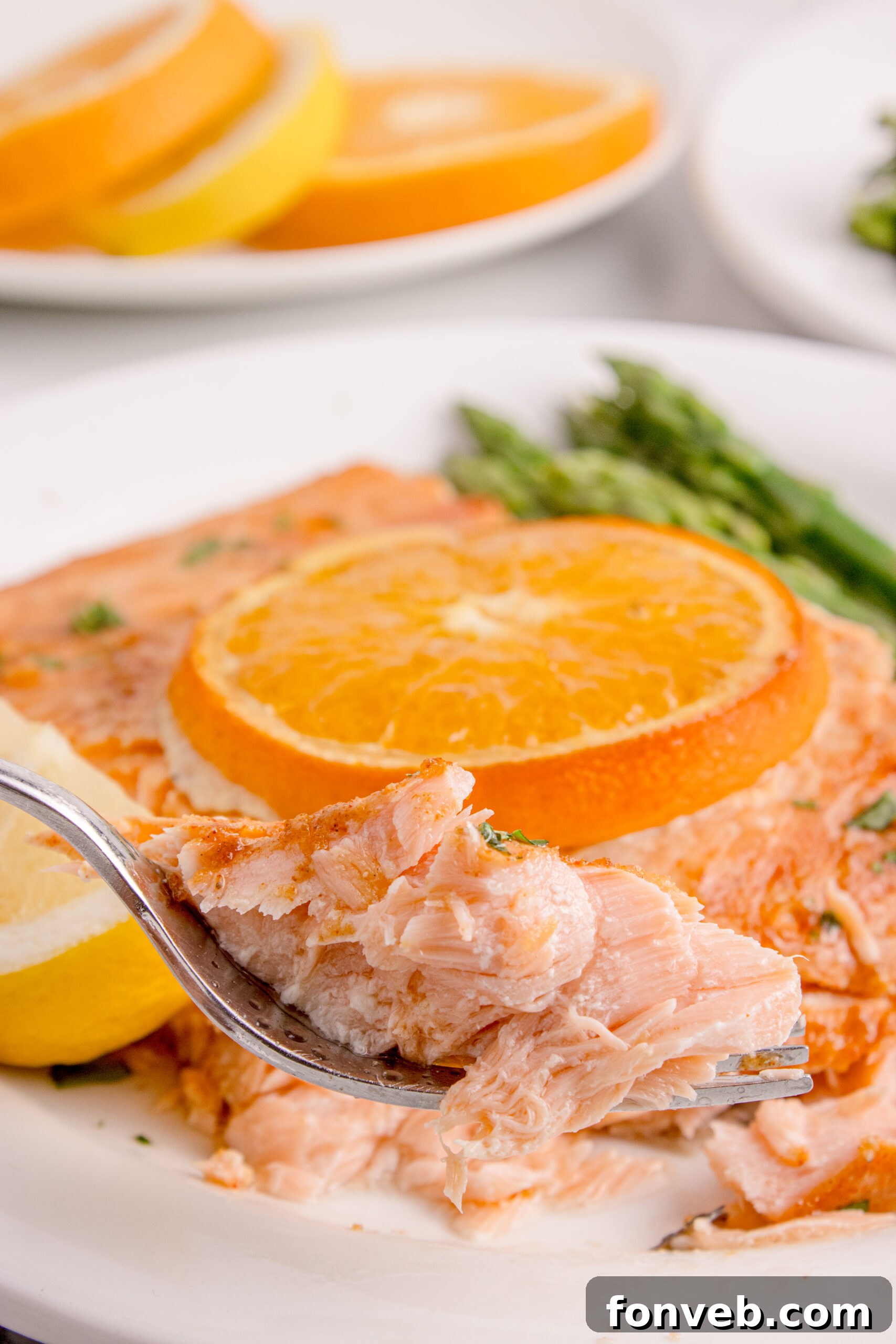 Effortless Honey Mustard Salmon Foil Grill 24 Grilled Honey Mustard Salmon on a white plate with a bite being lifted by a fork