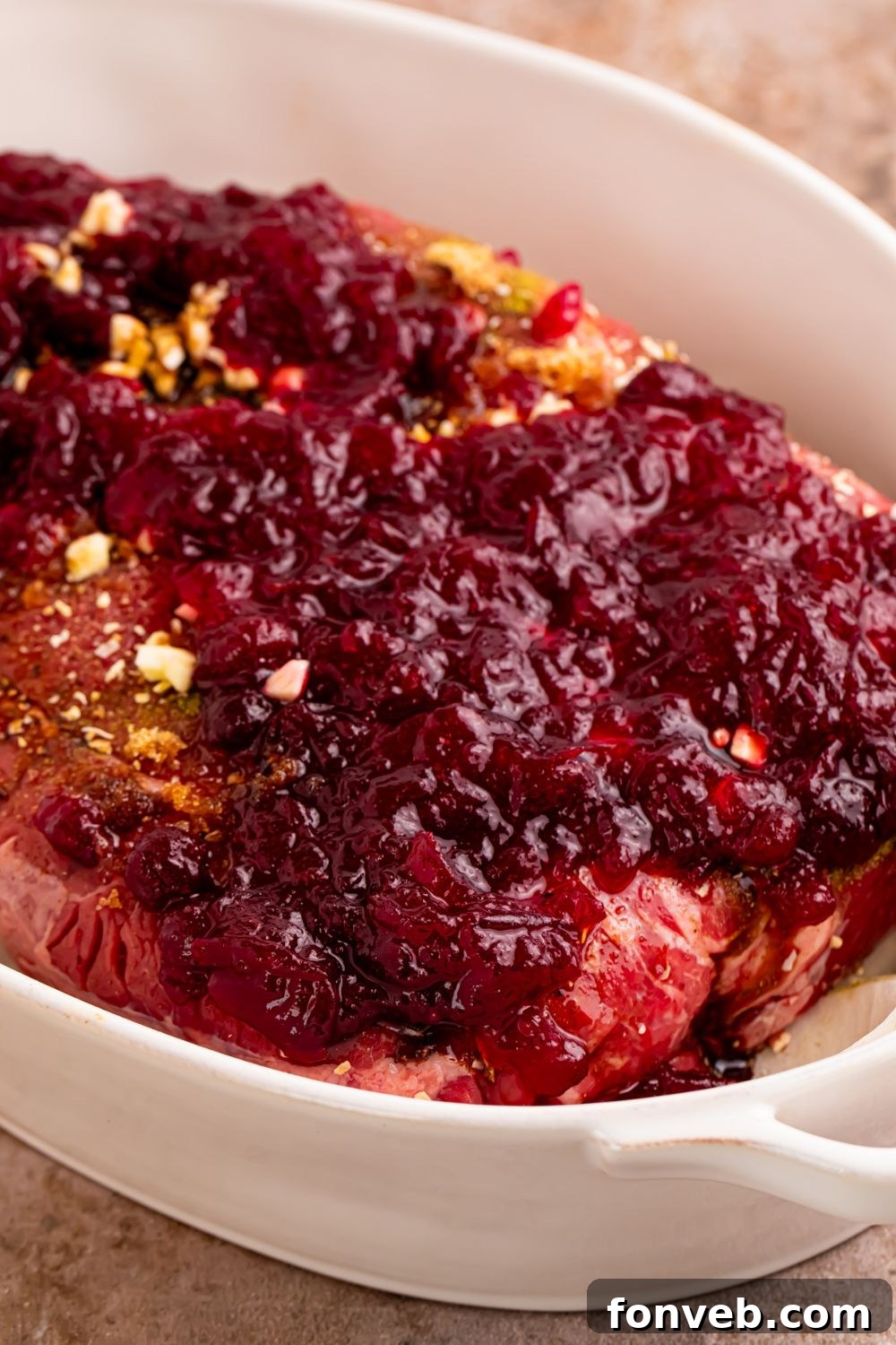 close up of raw Cranberry Pot Roast in pan with cranberry sauce on top 
