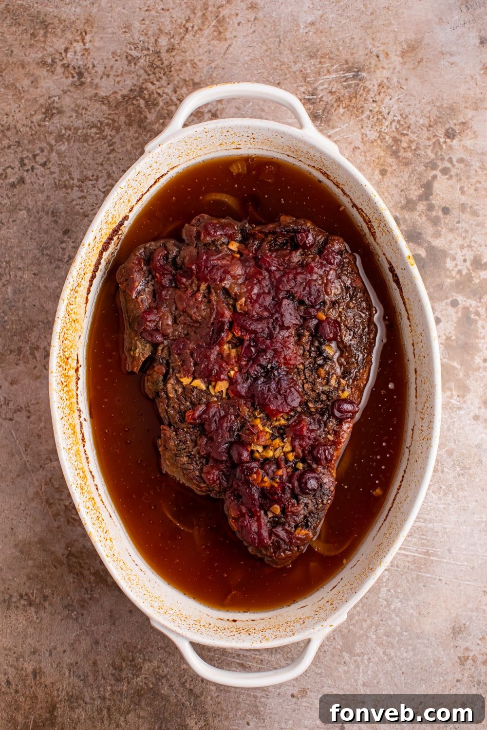 baked Cranberry Pot Roast in a casserole dish on table 