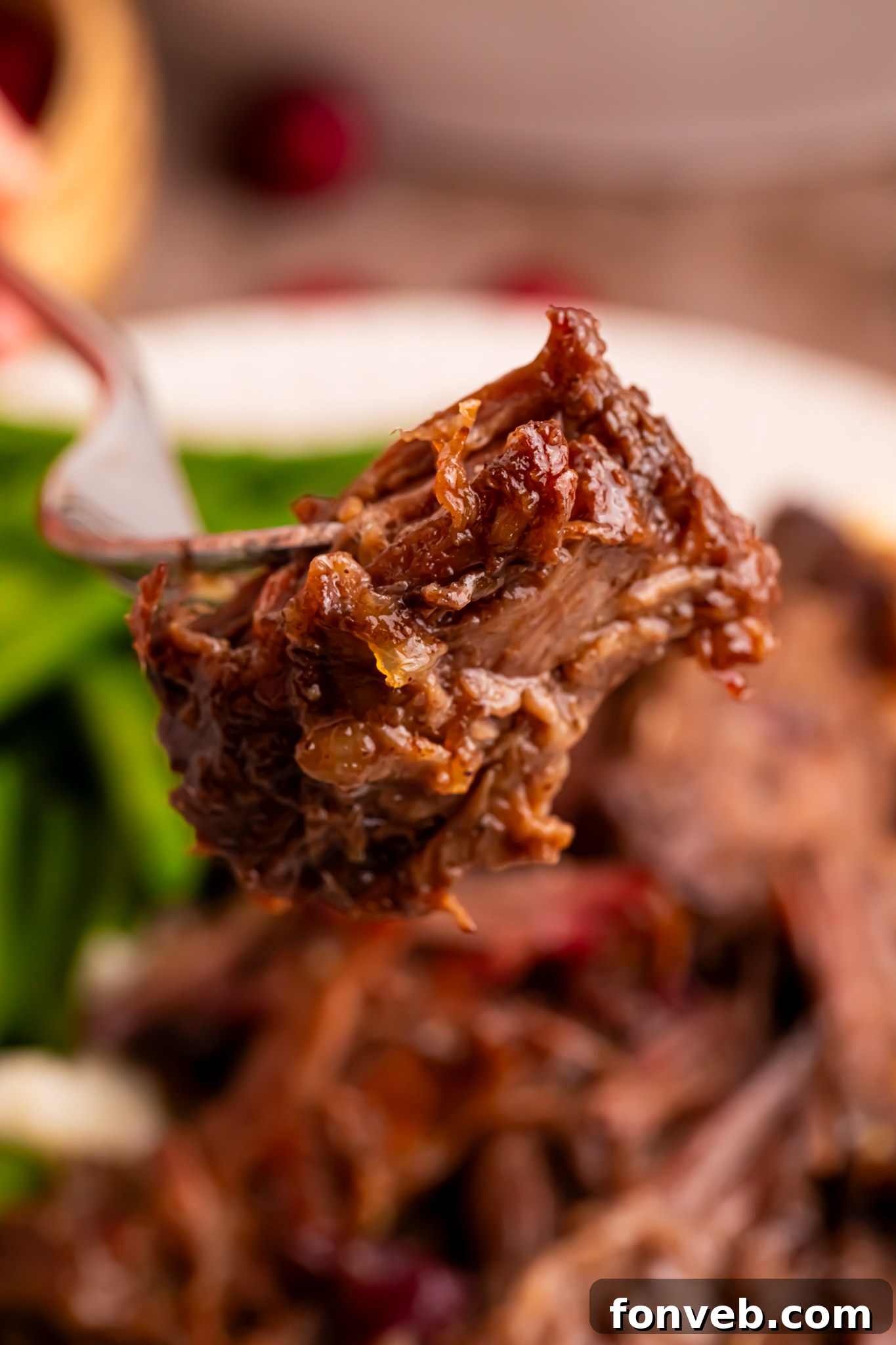 Cranberry Pot Roast shredded on a fork 