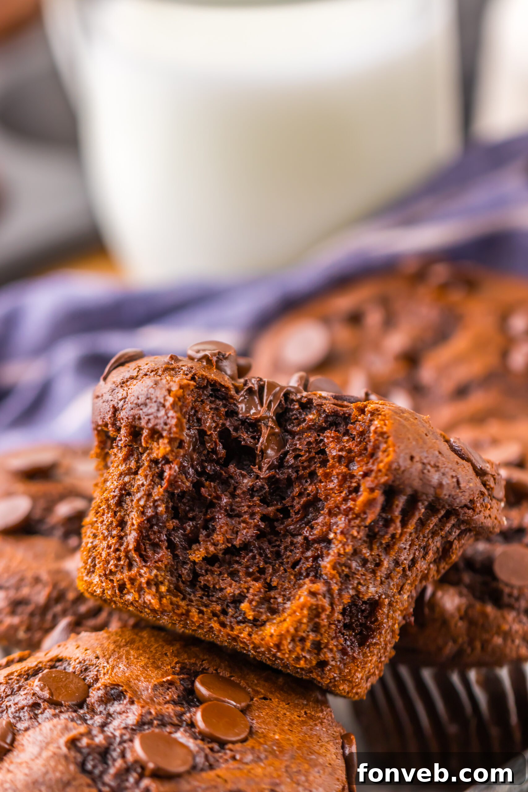 Costco Double Chocolate Muffins with one on top with a bite missing