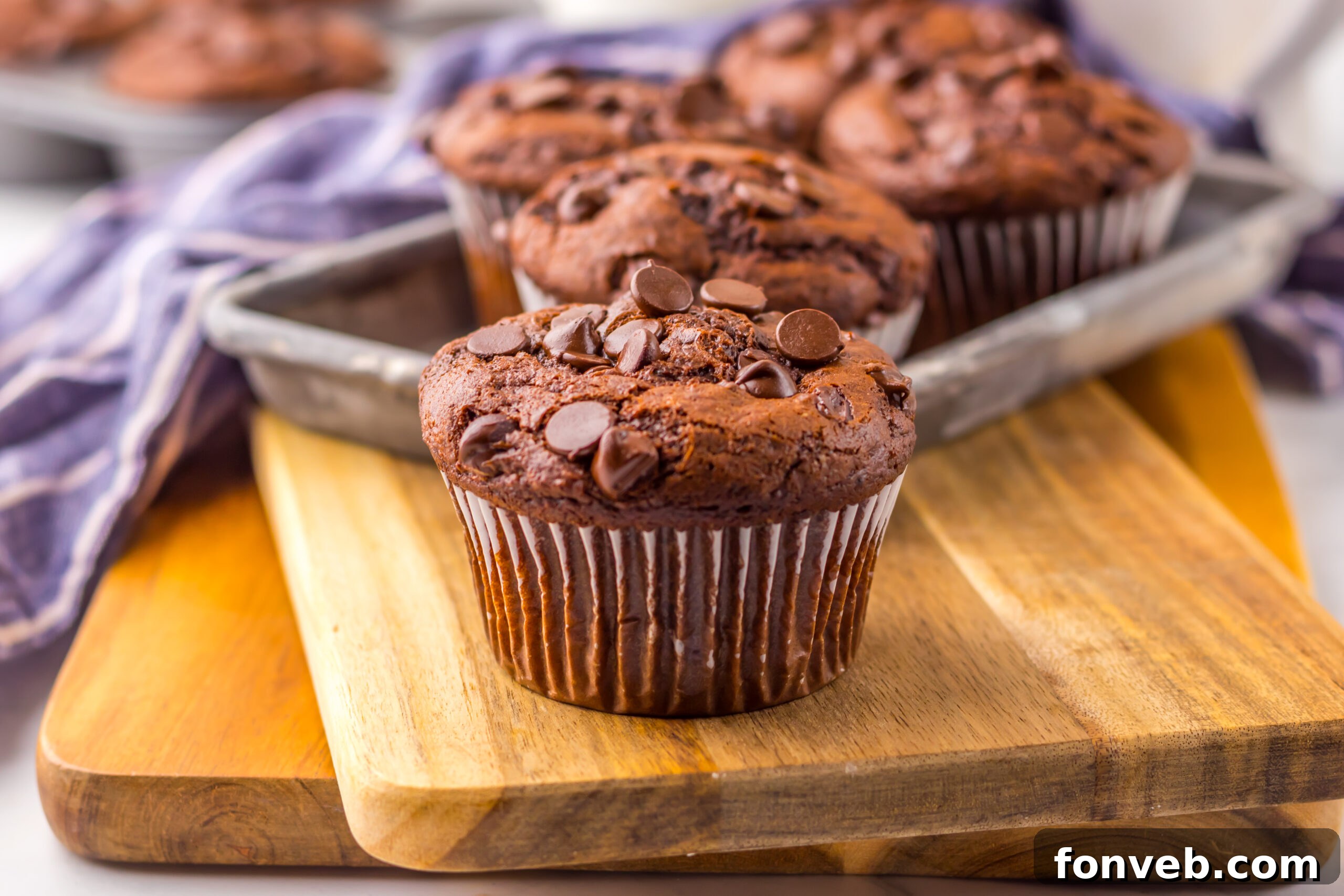 Costco Double Chocolate Muffins on a wooden cutting board up close