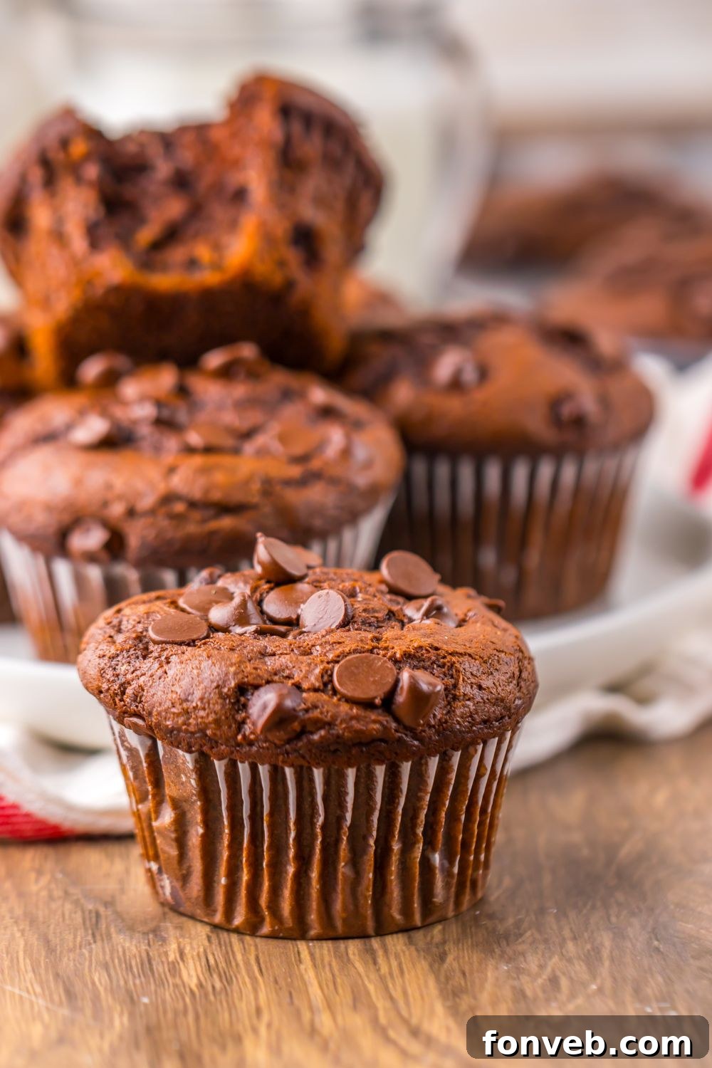 Costco Double Chocolate Muffins placed randomly on a table with a towel around muffins