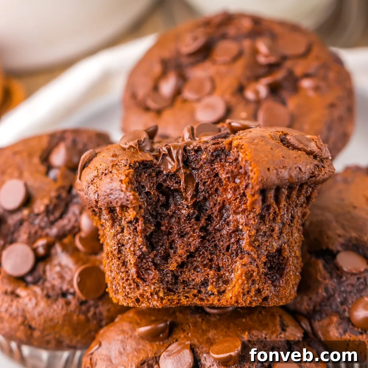 Costco Double Chocolate Muffins on plate with a bite taken out of one of the muffins