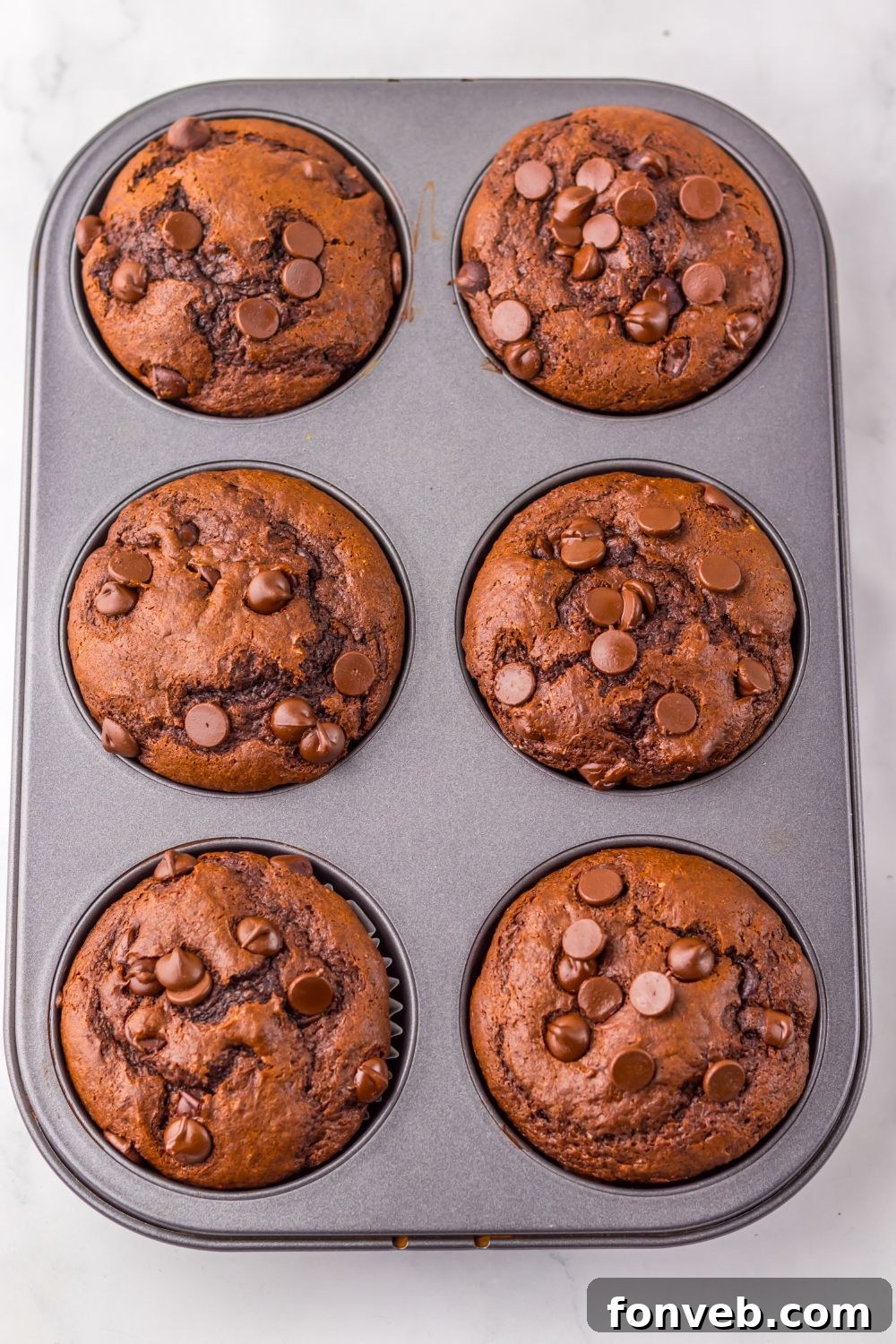 overhead look of muffin tin full of homemade Costco Double Chocolate Muffins