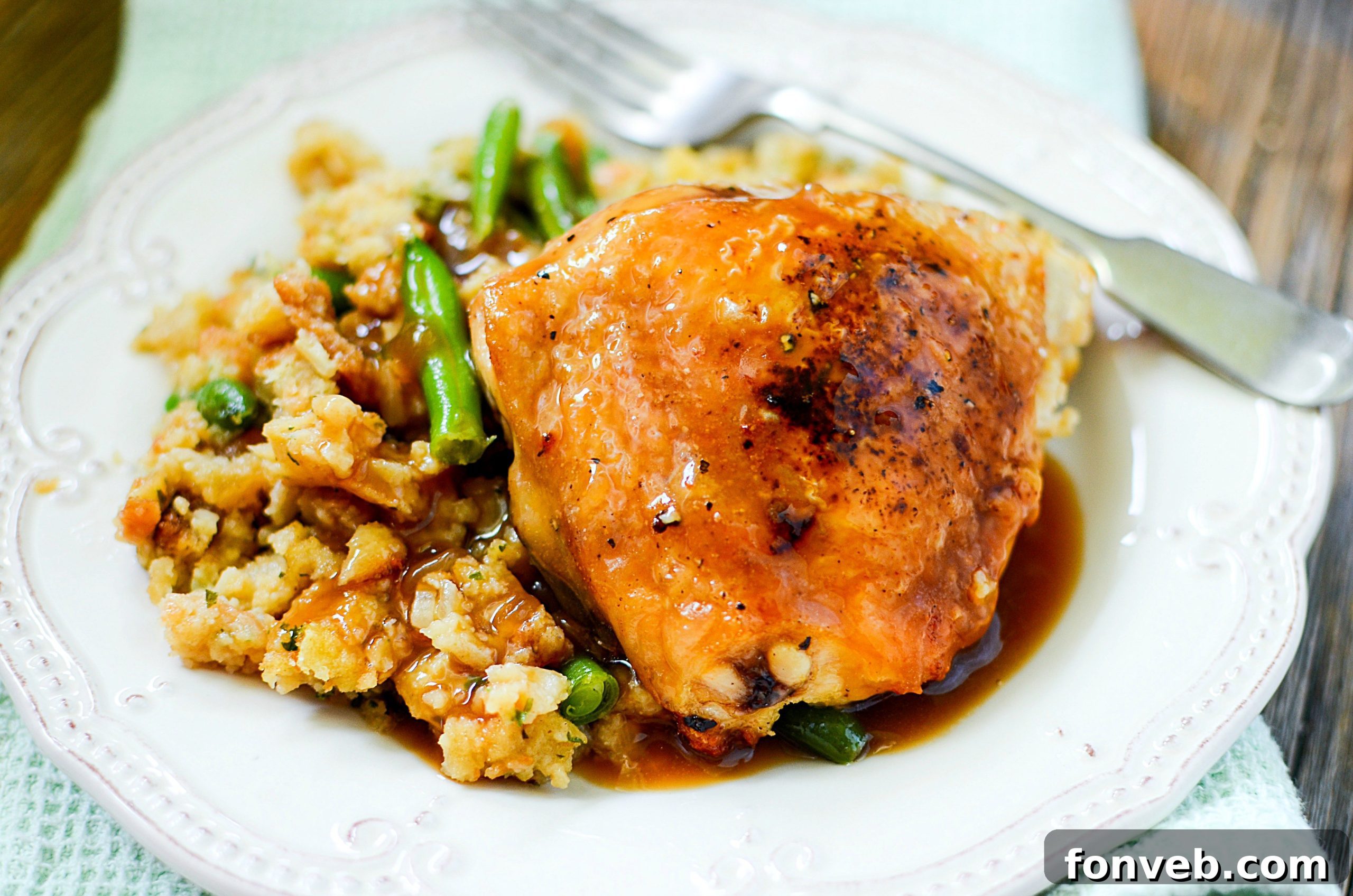 A generous pour of rich, brown gravy over a portion of the chicken and stuffing meal