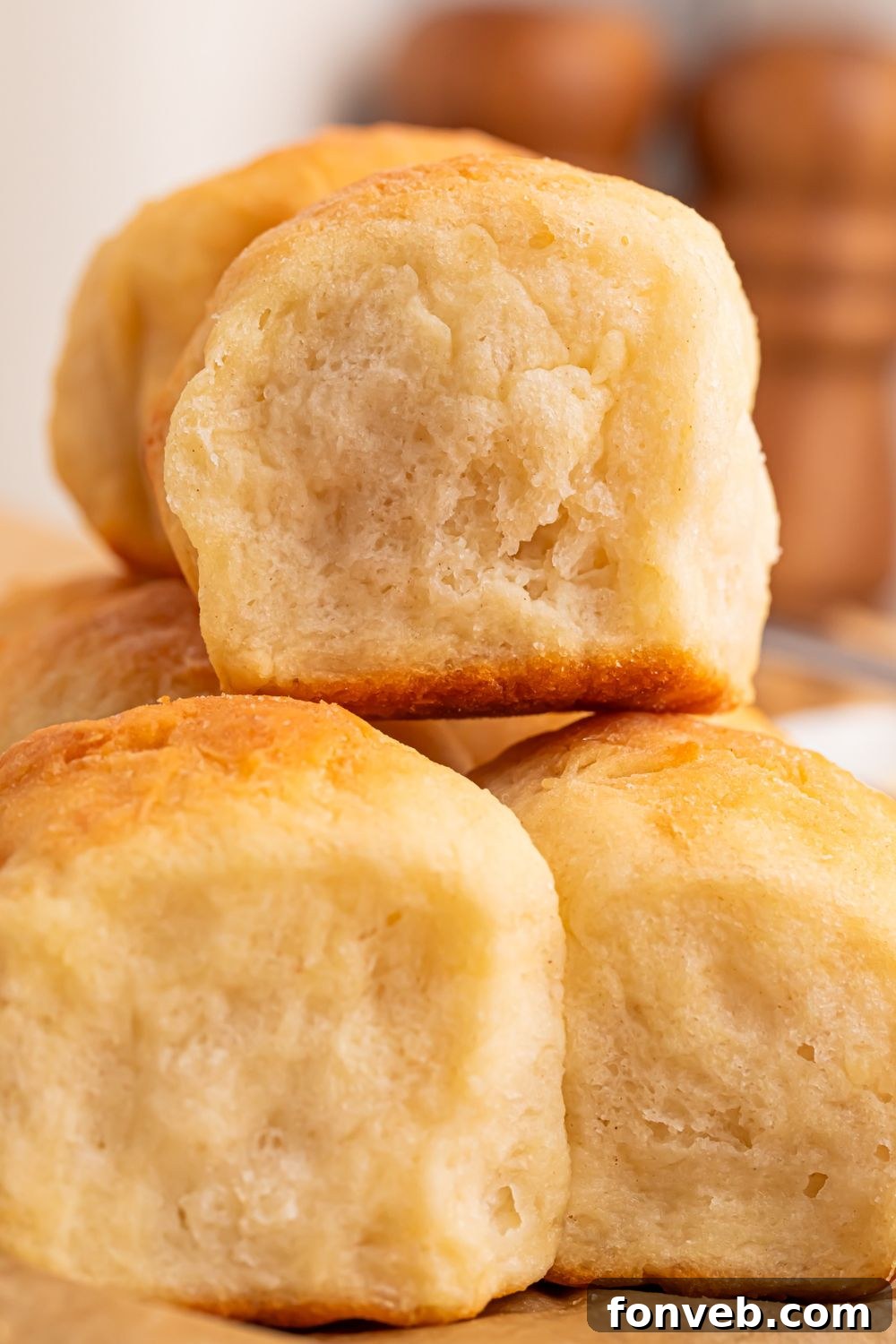 A close-up stack of 2-Ingredient Dinner Rolls on a table, highlighting their fluffy and airy interior, a testament to their soft texture and successful rise.