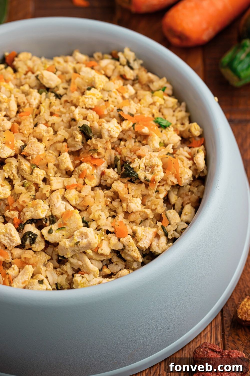 side view of a dog bowl full of Homemade Turkey and Rice Dog Food with Veggies
