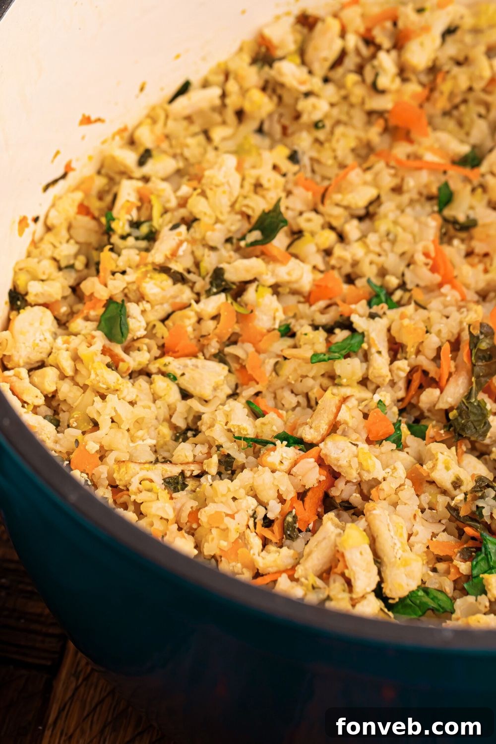 Homemade Turkey and Rice Dog Food with Veggies in a blue pot sitting on table 