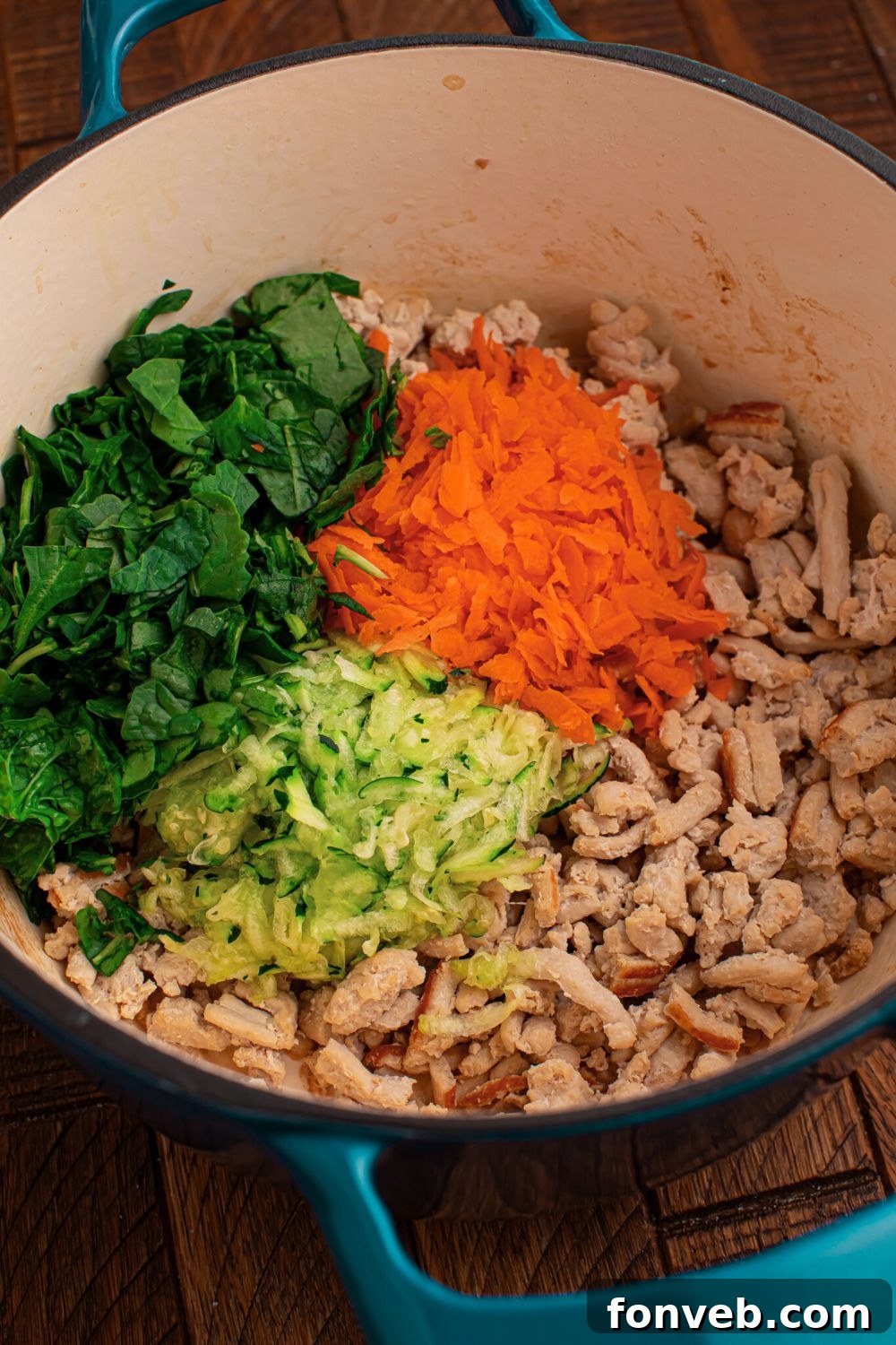 ground chicken in a pot with a mix of veggies and herbs 