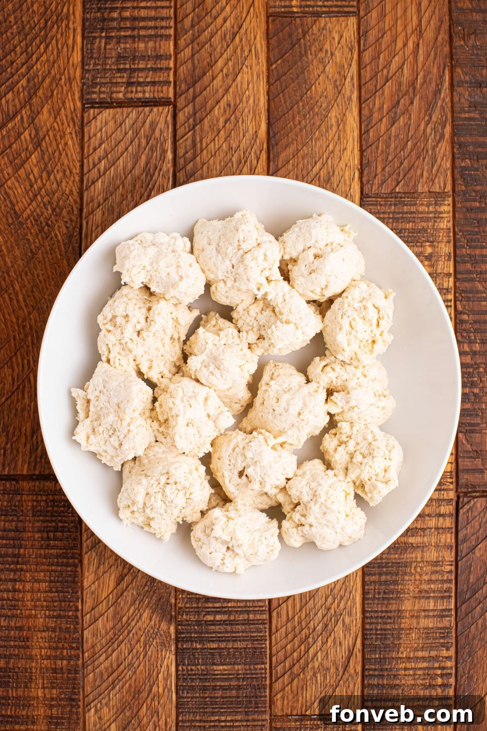 2-Ingredient Buttery Garlic Parmesan Breadsticks 8 balls of 2 Ingredient Garlic Parmesan Breadsticks dough on a plate on the table