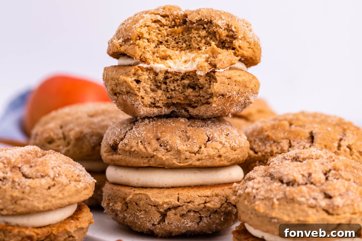 Pillowy Soft Spiced Apple Cider Whoopie Pies 2 Pile of Apple Cider Whoopie Pies stacked with a bite missing from the top one