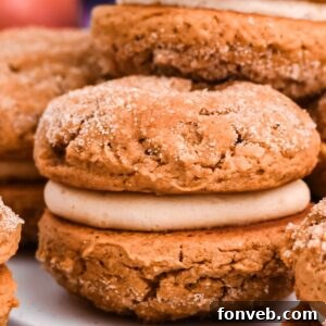 Pillowy Soft Spiced Apple Cider Whoopie Pies 15 A delicious stack of Apple Cider Whoopie Pies with a creamy filling, topped with cinnamon sugar.