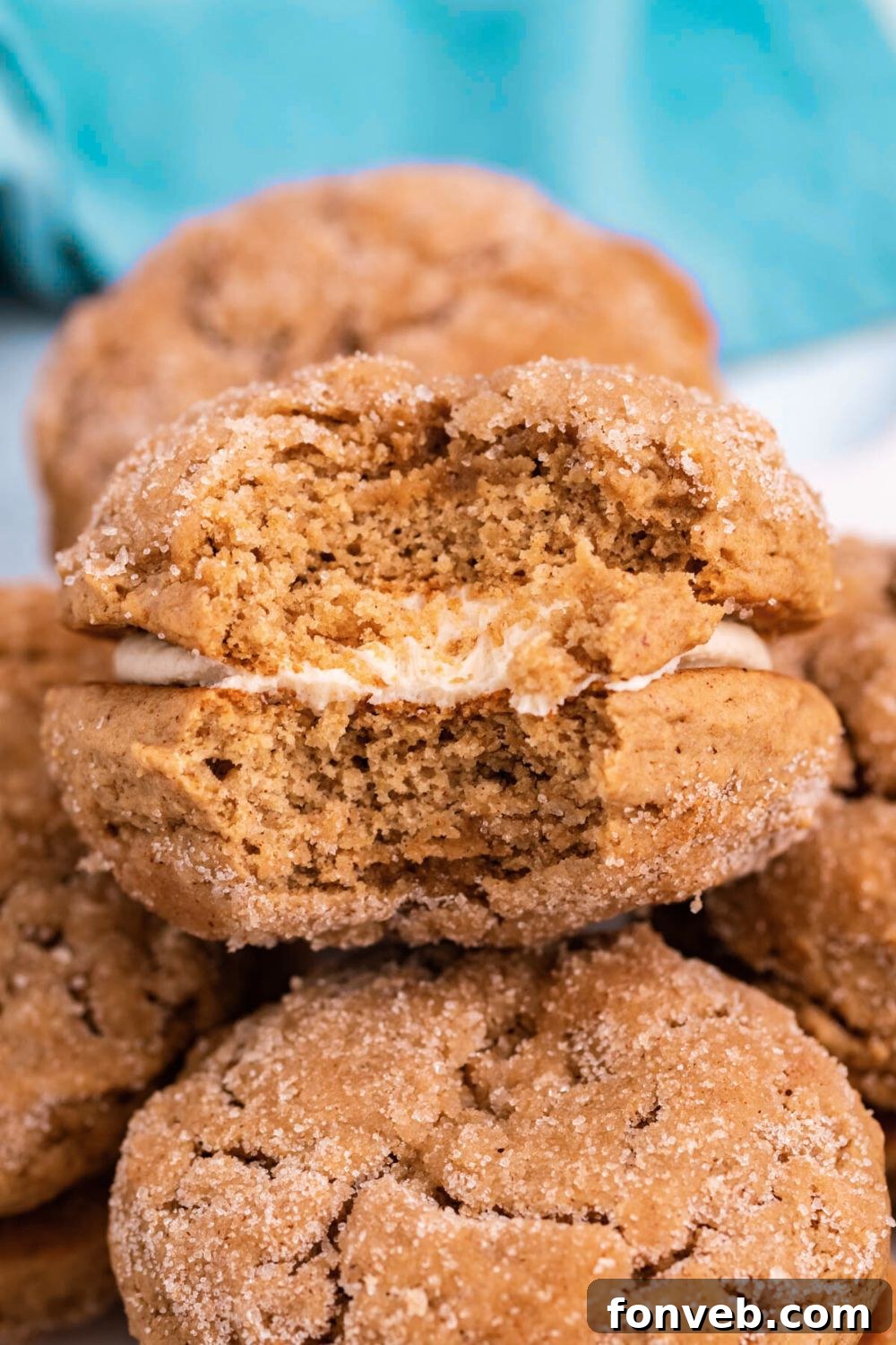 Pillowy Soft Spiced Apple Cider Whoopie Pies 7 Apple Cider Whoopie Pies stacked on table with one that has a bite taken out of it