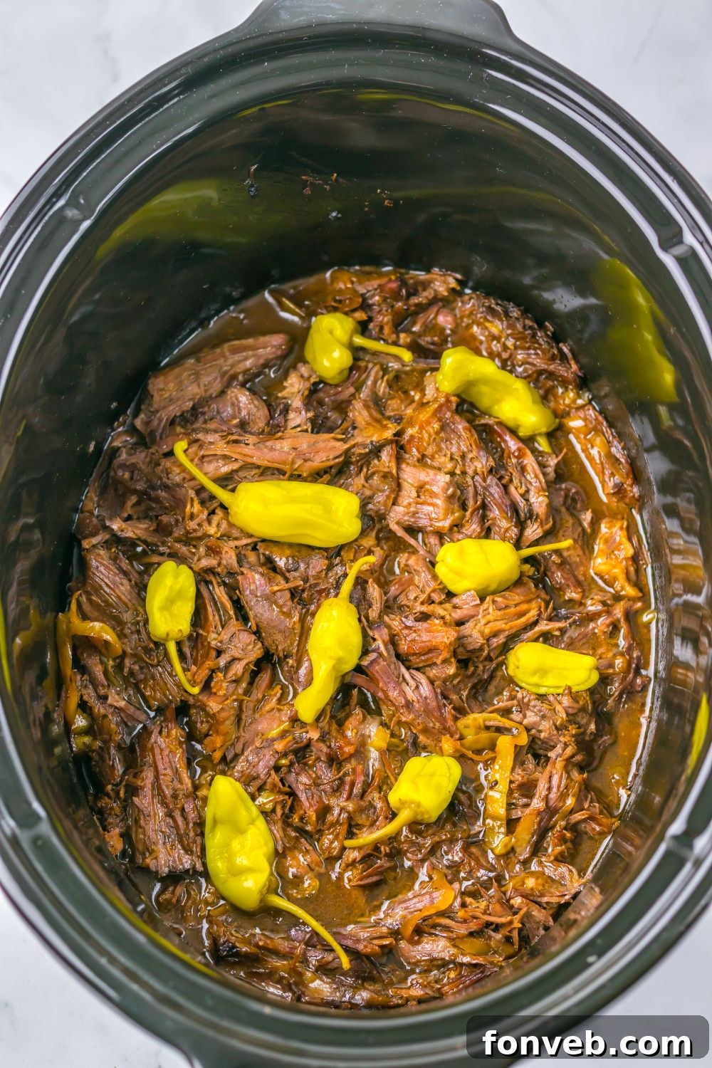 Deliciously Simple Slow Cooker Mississippi Pot Roast Sliders 8 Slow Cooker Mississippi Pot Roast in a slow cooker with more peppers on top