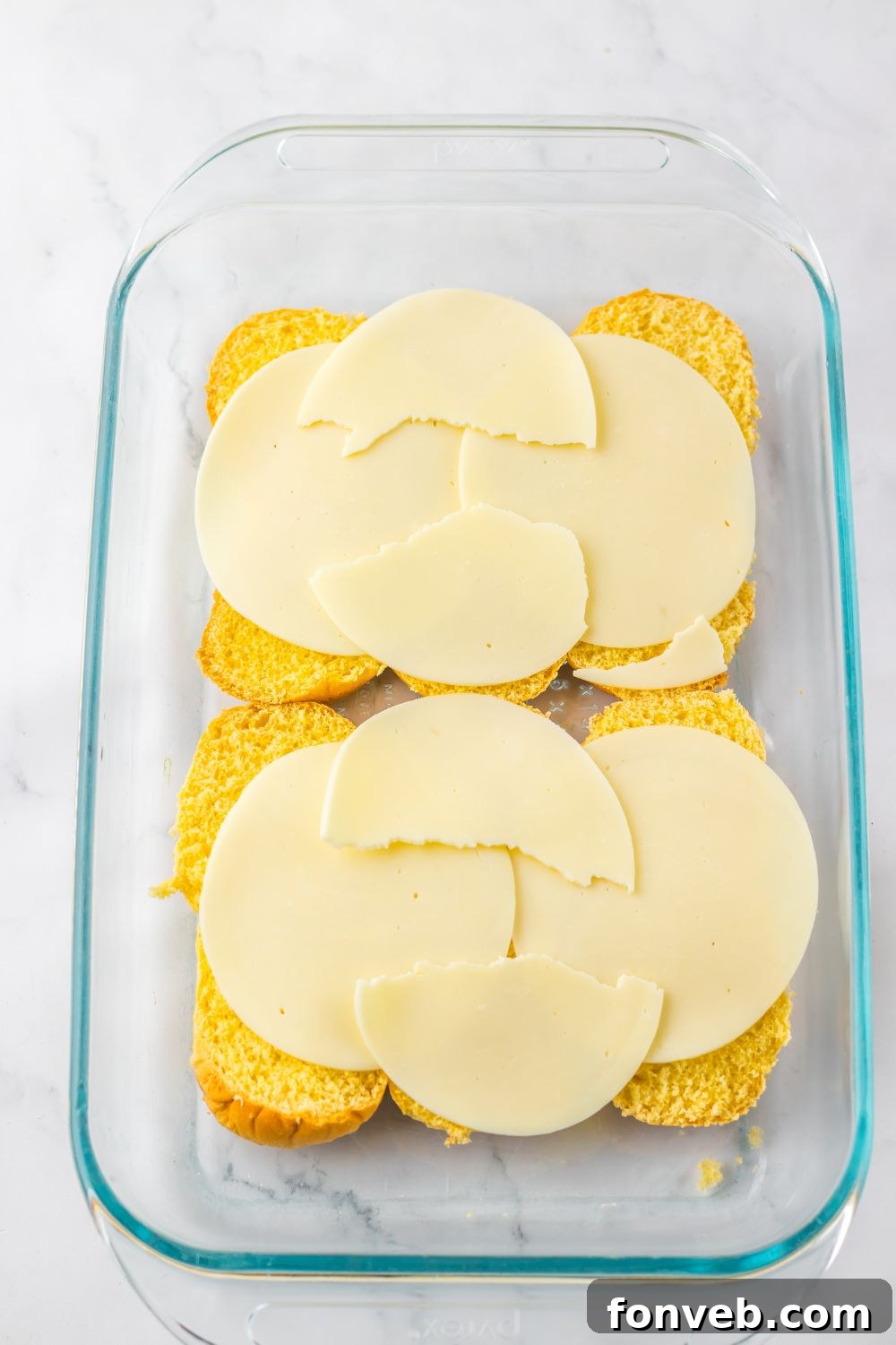 Deliciously Simple Slow Cooker Mississippi Pot Roast Sliders 9 rolls with provolone cheese spread over the top of the buns