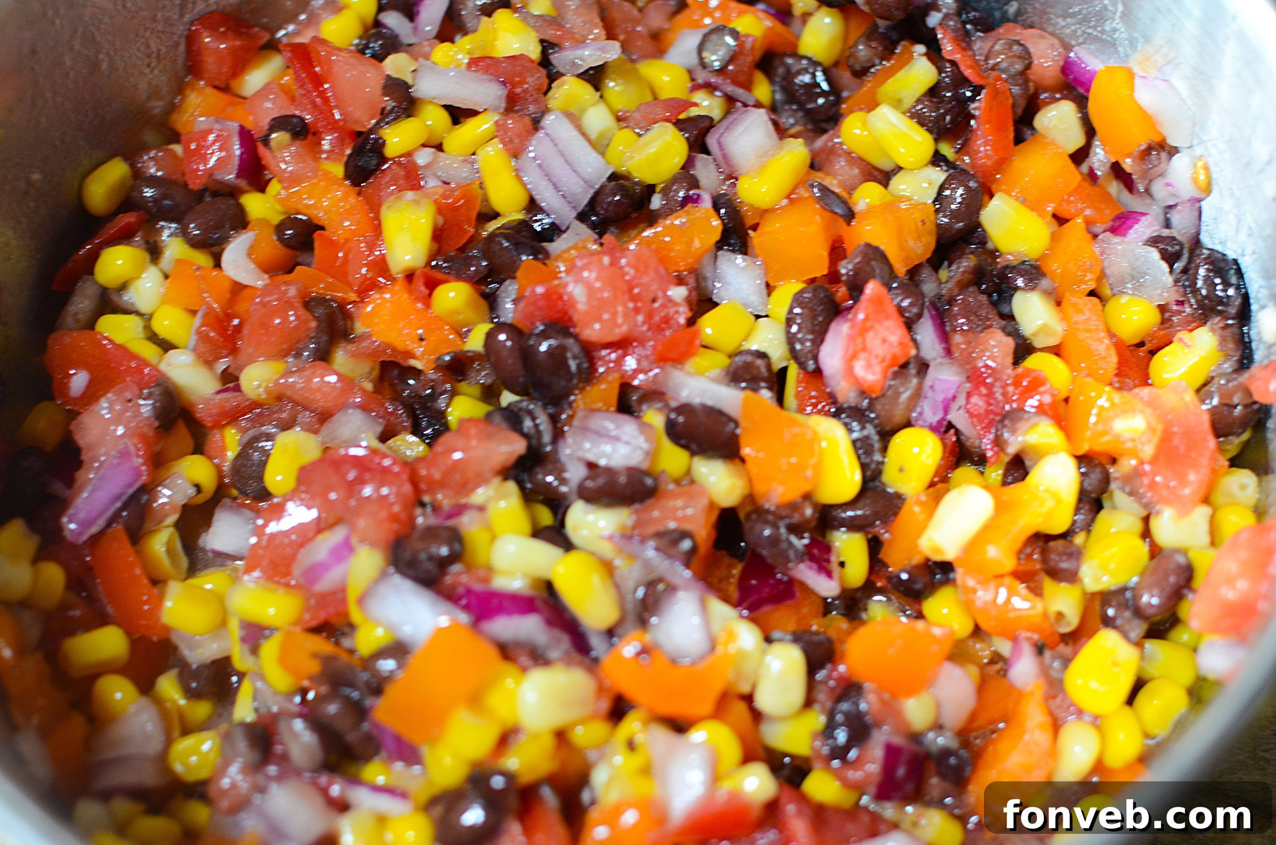 Ingredients for Cowboy Caviar laid out on a cutting board, before mixing