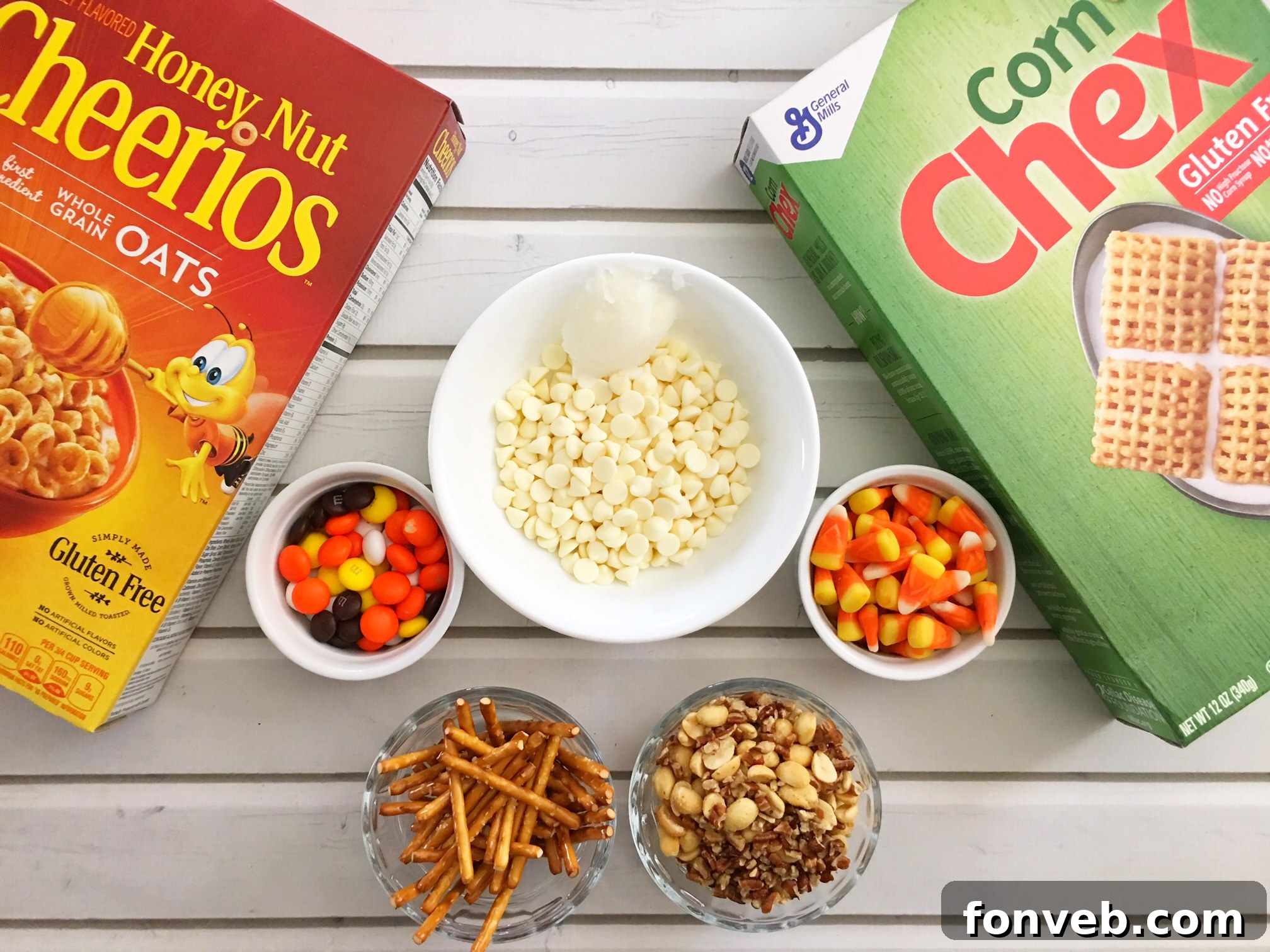 Close-up of Fall Harvest Crack spread on a baking sheet, showing the melted white chocolate coating pretzels, cereals, and candies.
